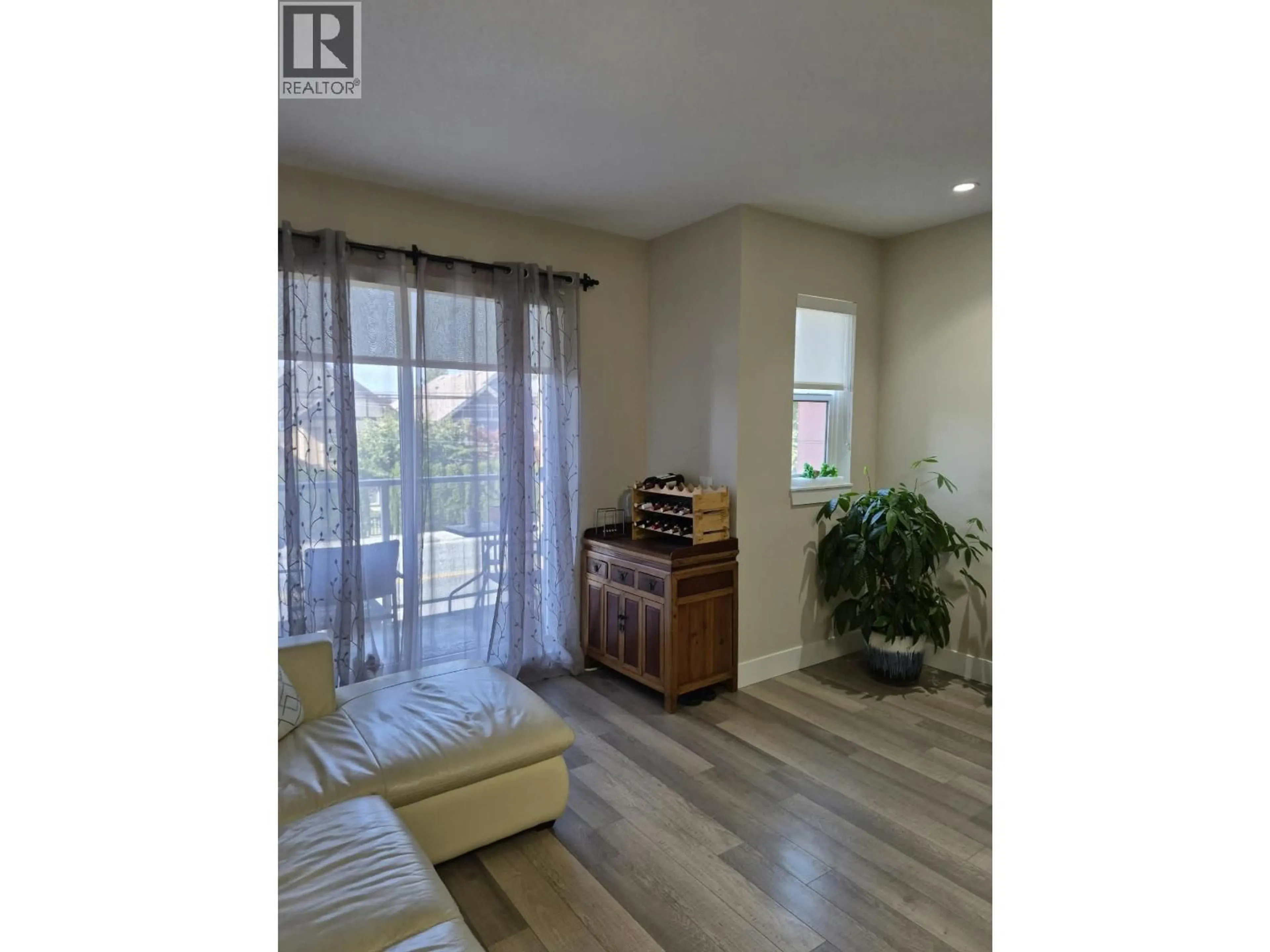Living room with furniture, wood/laminate floor for 3 - 8288 NO. 1 ROAD, Richmond British Columbia V7C1T9