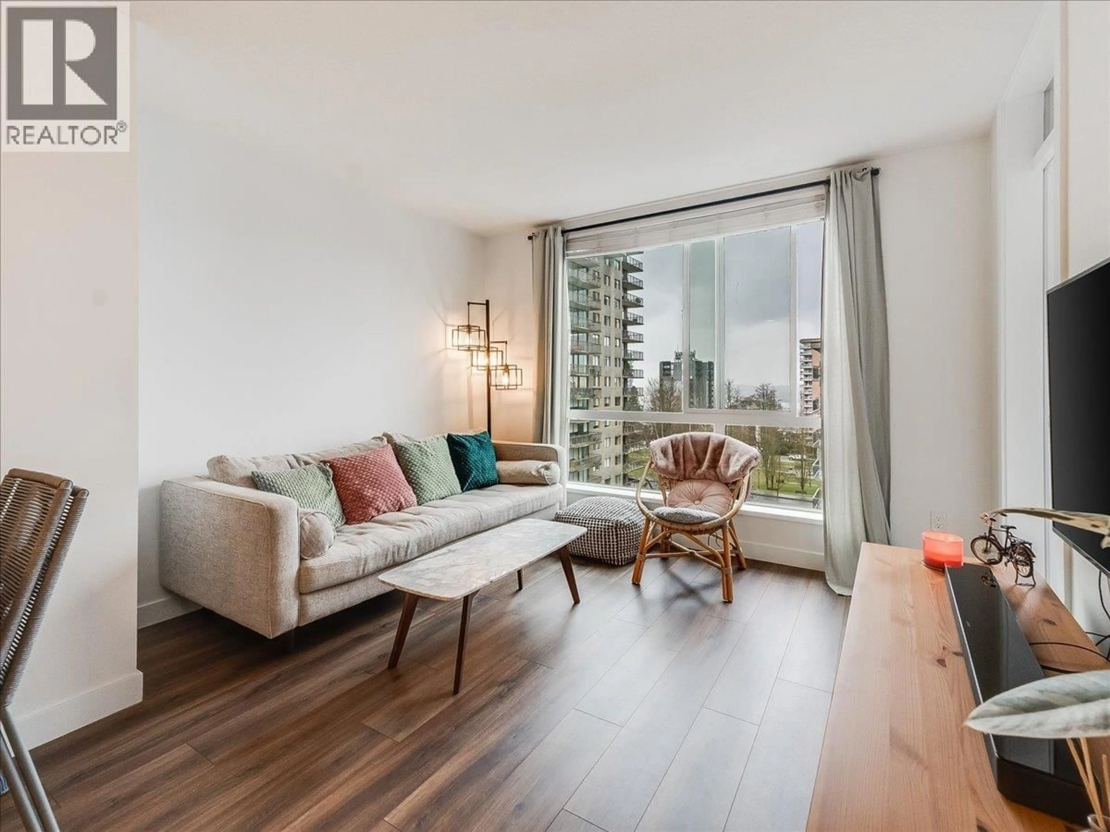 Living room with furniture, wood/laminate floor for 406 - 108 8TH STREET, North Vancouver British Columbia V7L0H1