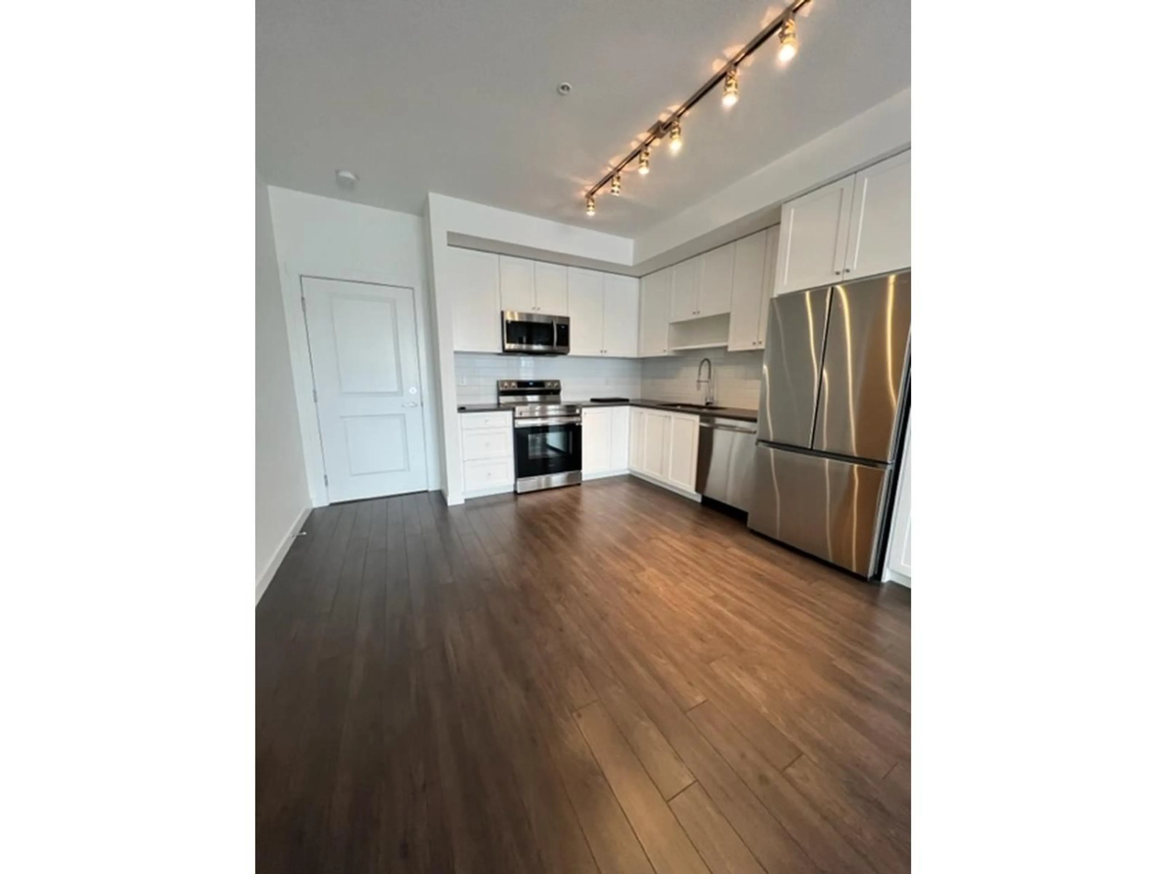 Open concept kitchen, wood/laminate floor for 202 - 15815 85 AVENUE, Surrey British Columbia V4N6X5