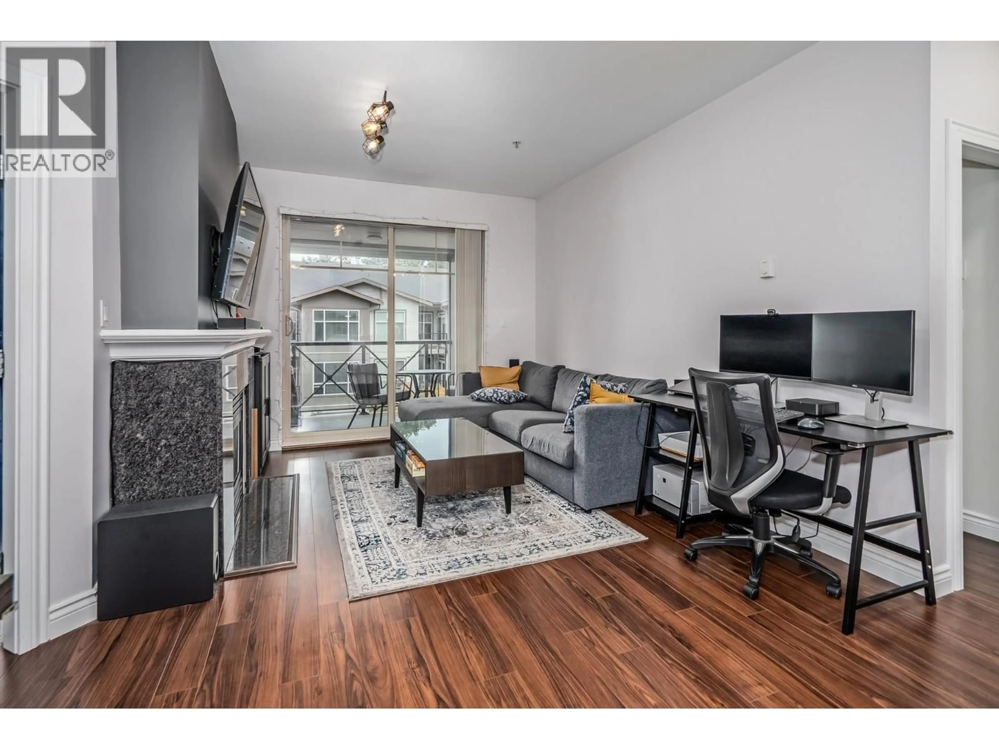 Living room with furniture, wood/laminate floor for 408 - 2330 WILSON AVENUE, Port Coquitlam British Columbia V3C1Z6