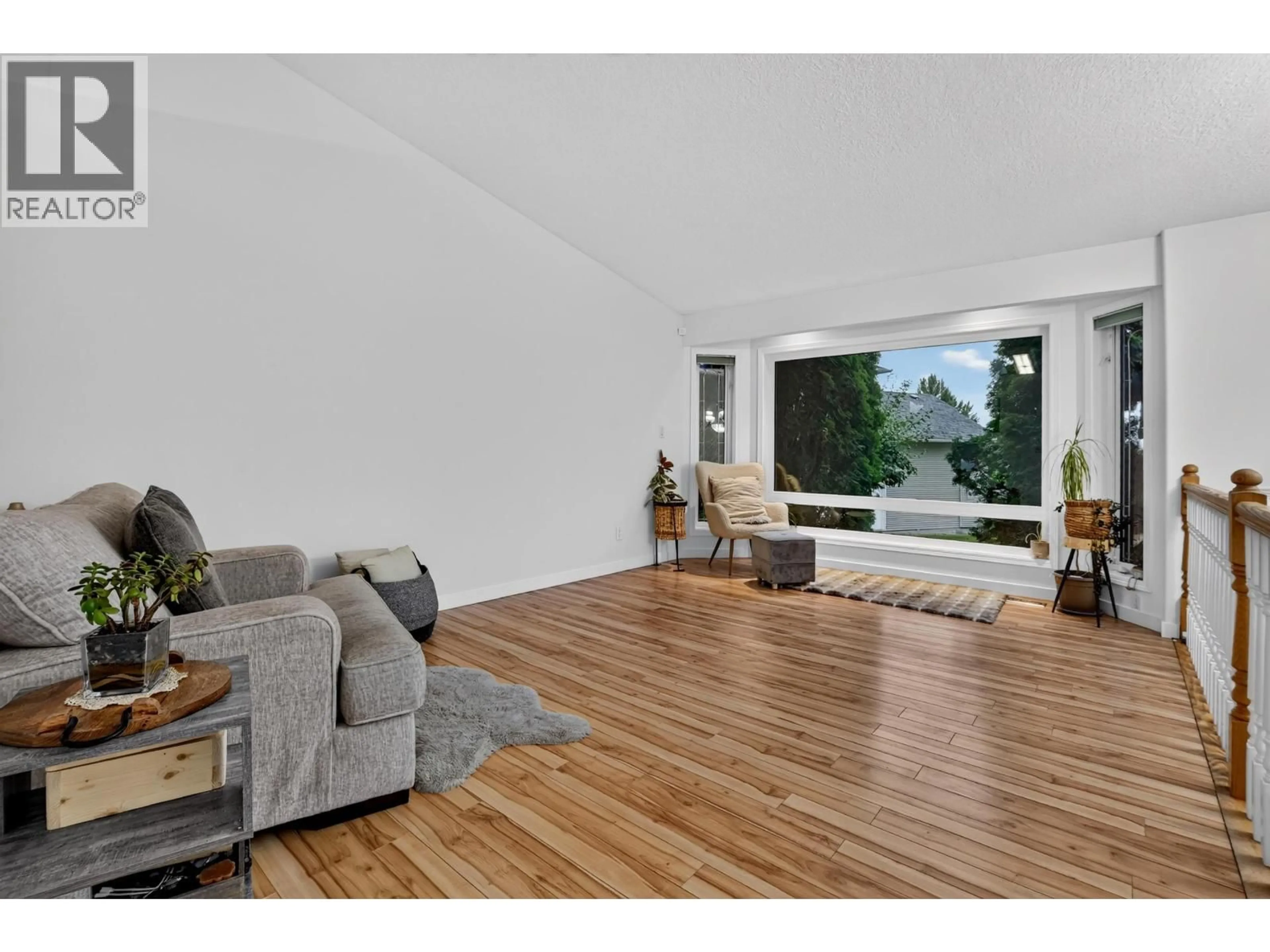Living room with furniture, wood/laminate floor for 6320 BLISS POINT, Prince George British Columbia V2K5A7
