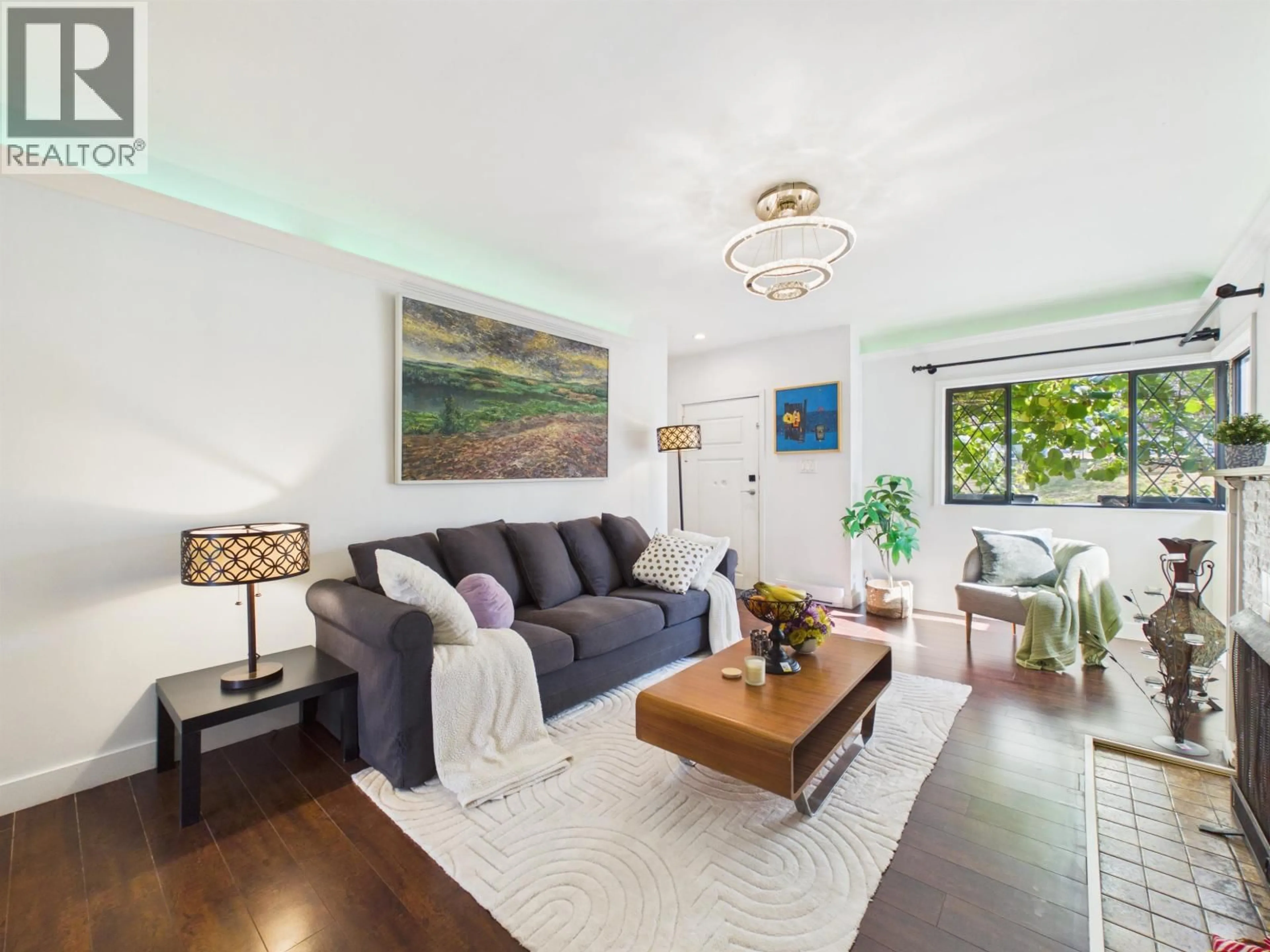Living room with furniture, wood/laminate floor for 4605 RUPERT STREET, Vancouver British Columbia V5R2J4