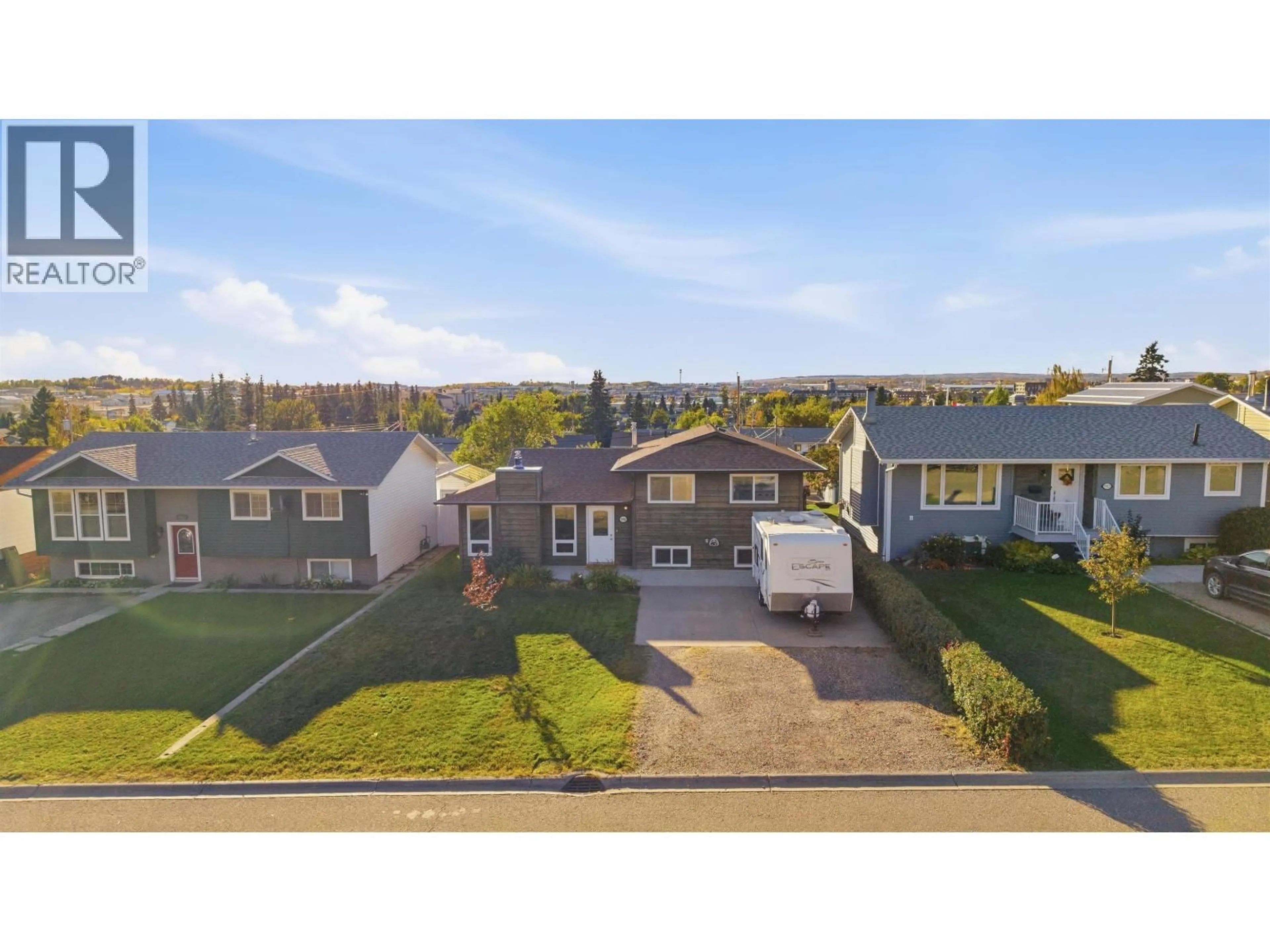 A pic from outside/outdoor area/front of a property/back of a property/a pic from drone, street for 9008 87 STREET, Fort St. John British Columbia V1J5H4