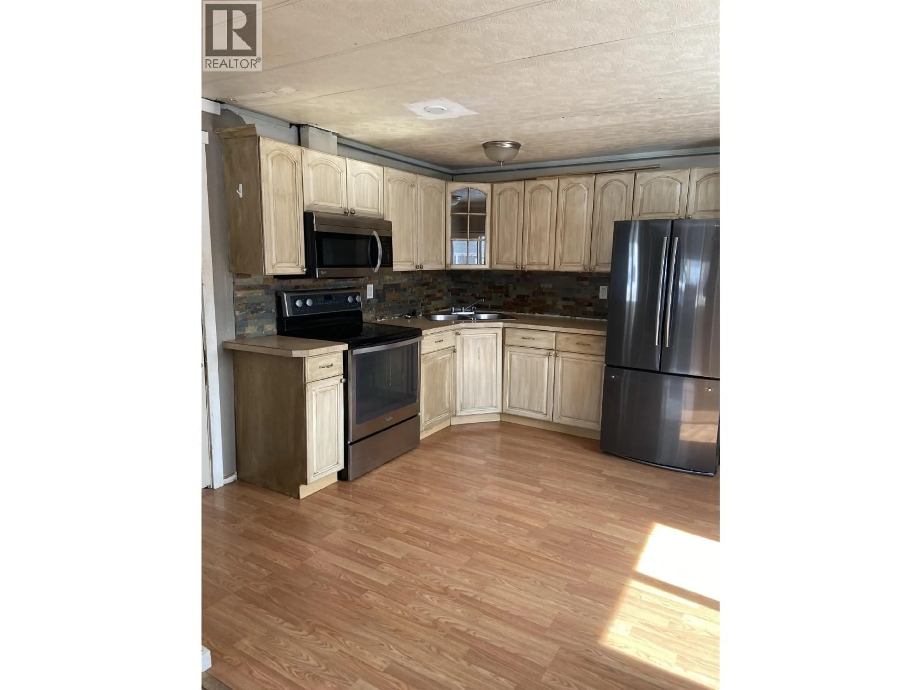 Open concept kitchen, wood/laminate floor for 73 - 12842 OLD HOPE ROAD, Charlie Lake British Columbia V0C1H0