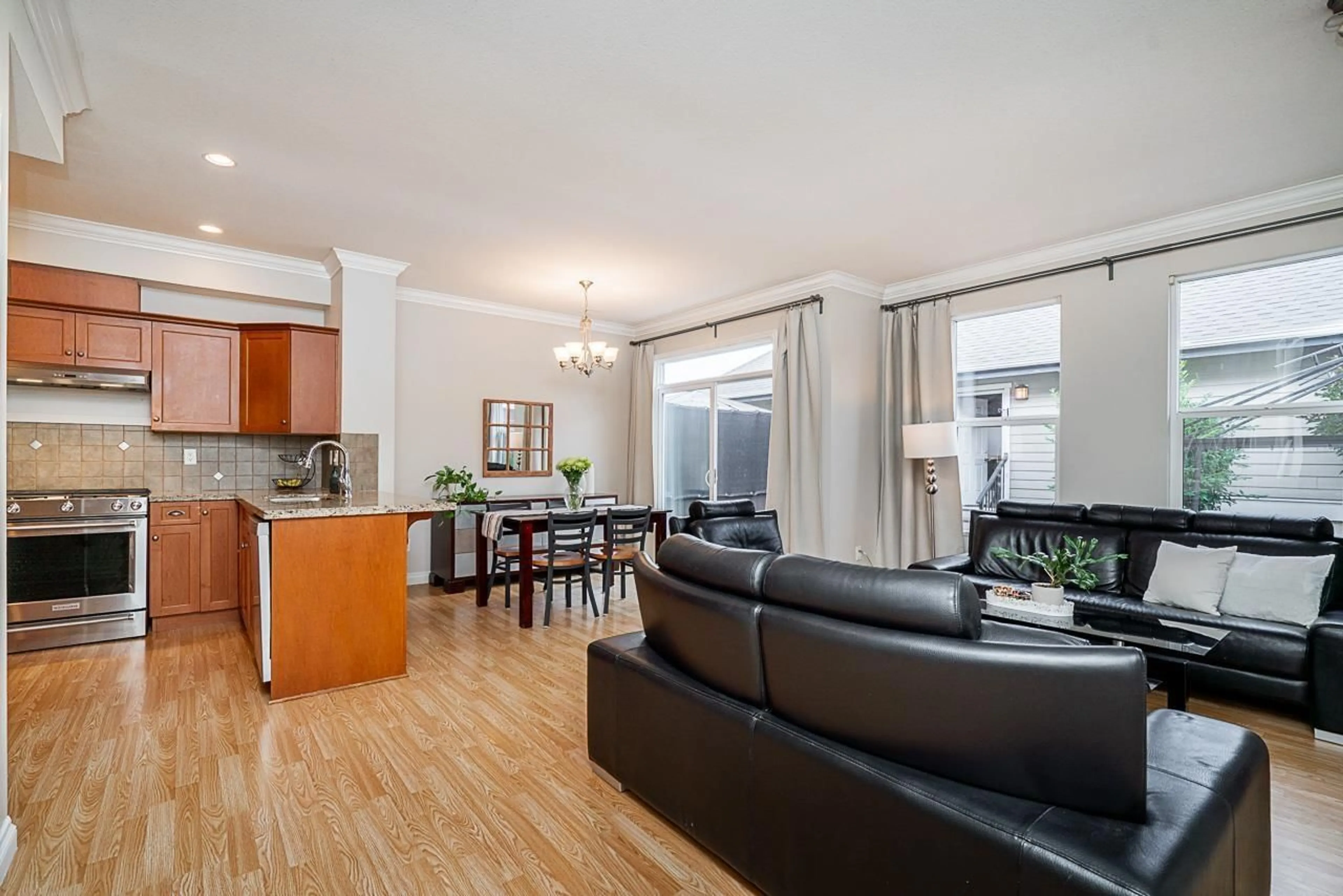 Living room with furniture, wood/laminate floor for 4 - 18055 70TH AVENUE, Surrey British Columbia V3S6X3