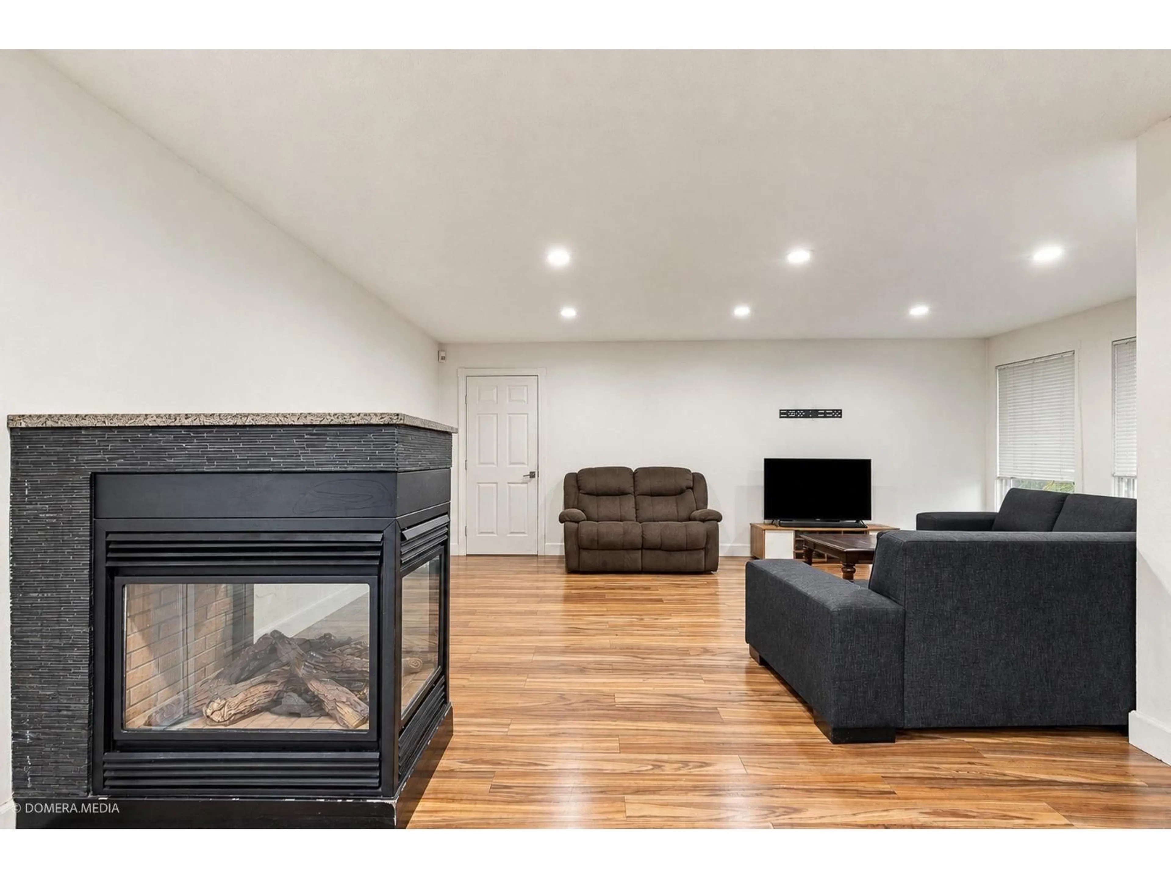 Living room with furniture, wood/laminate floor for 9084 PRINCE CHARLES BOULEVARD, Surrey British Columbia V3V1R5