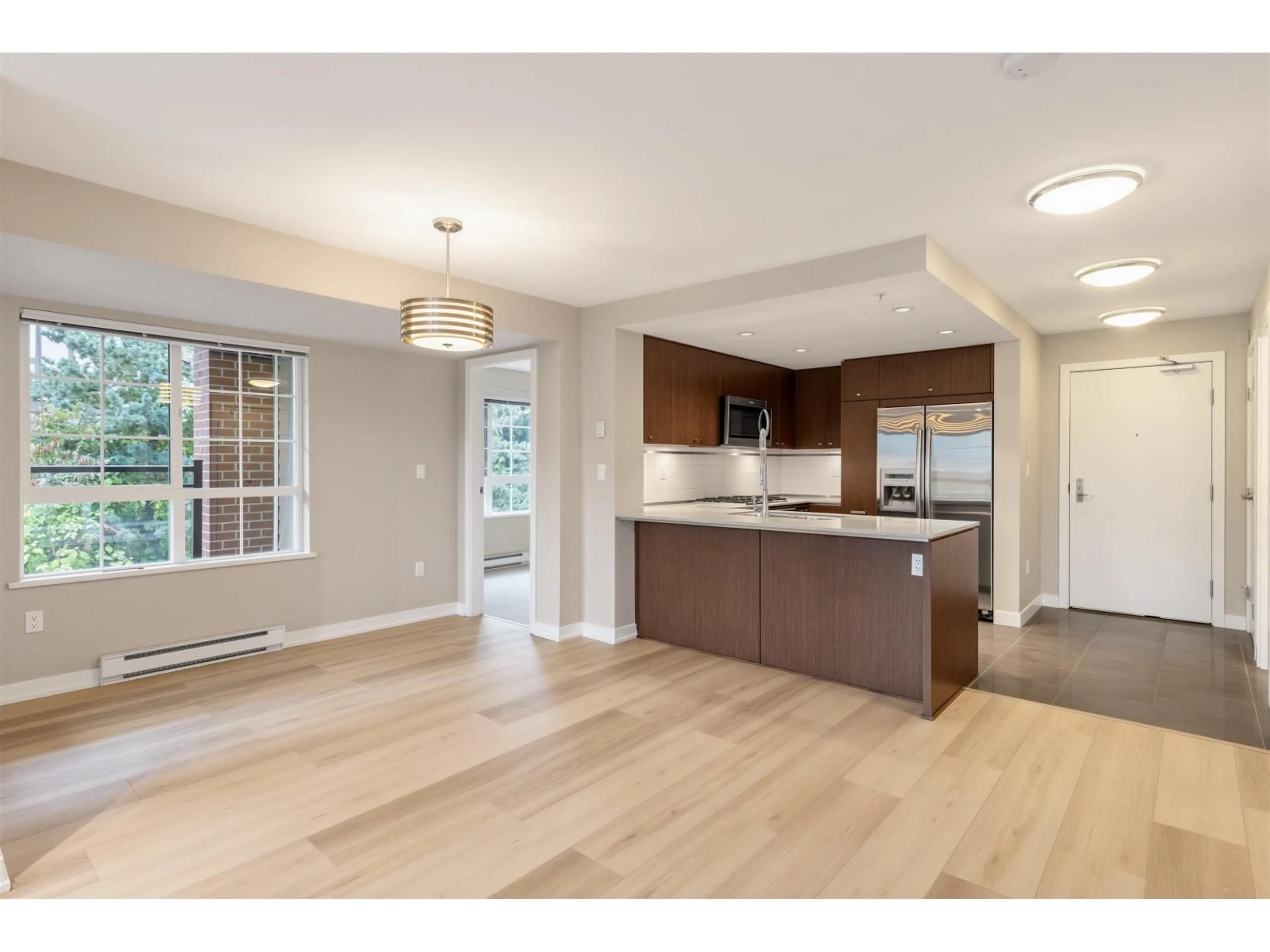 Open concept kitchen, wood/laminate floor for 205 - 2940 KING GEORGE BOULEVARD, Surrey British Columbia V4P1A2