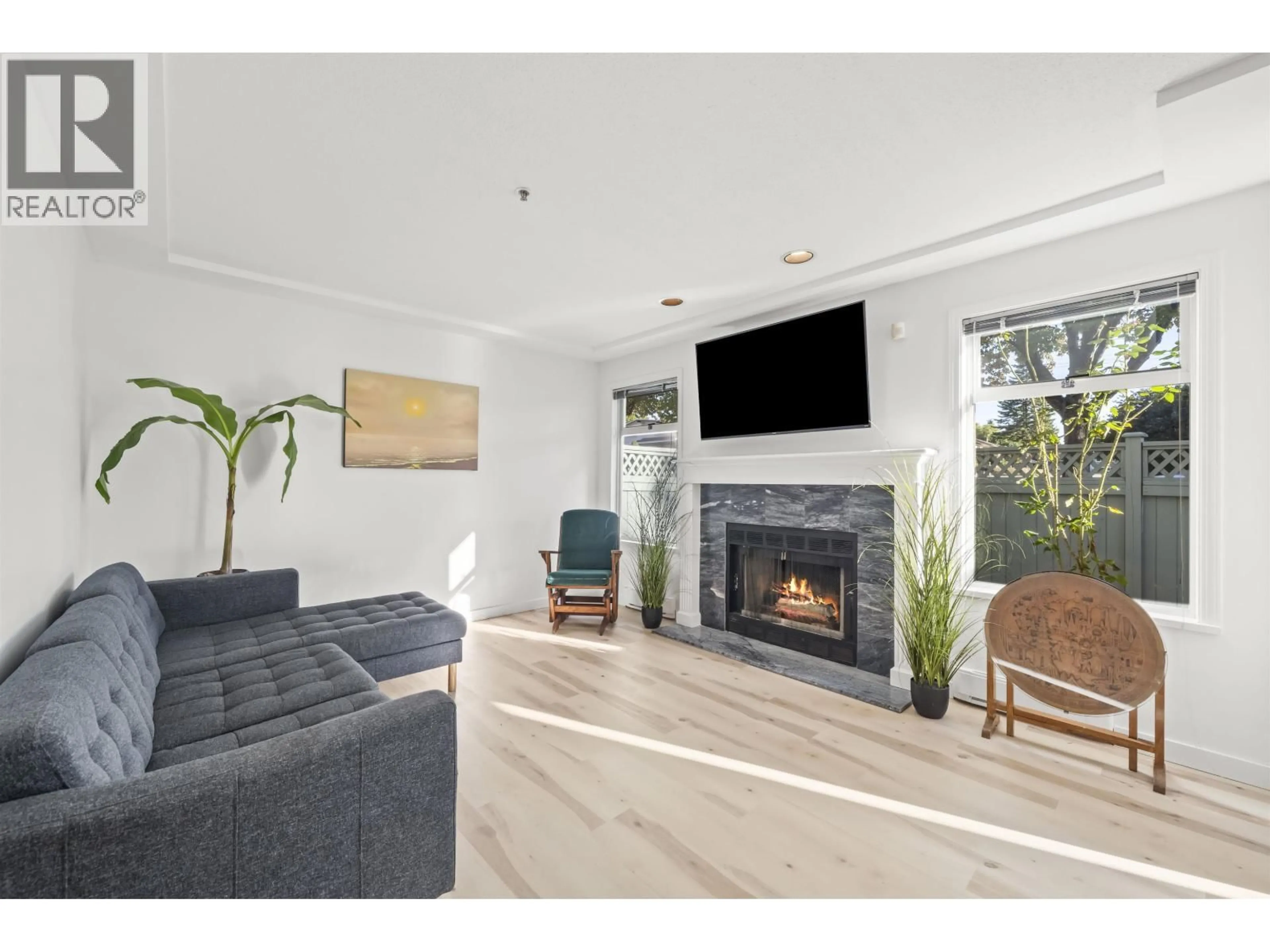 Living room with furniture, wood/laminate floor for 1 - 7110 BARNET ROAD, Burnaby British Columbia V5A4S2