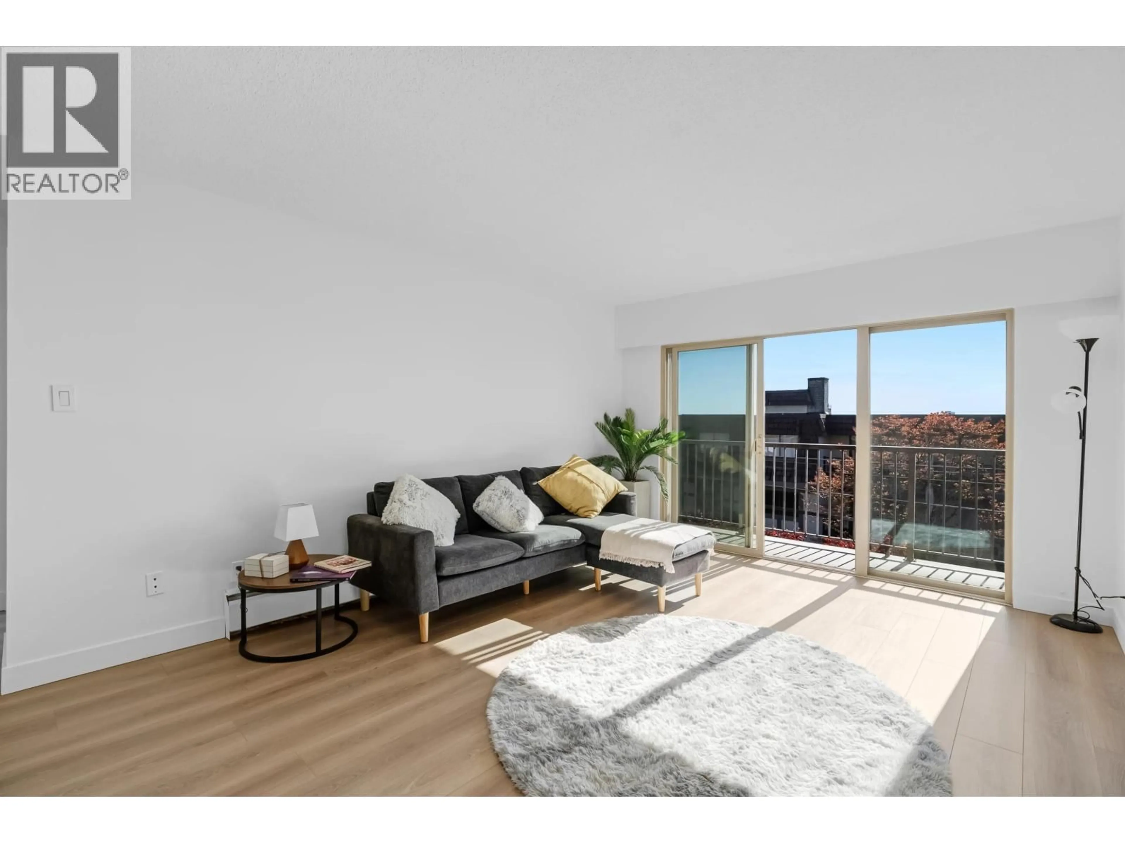 Living room with furniture, wood/laminate floor for 201 - 225 3RD STREET, North Vancouver British Columbia V7M1E9
