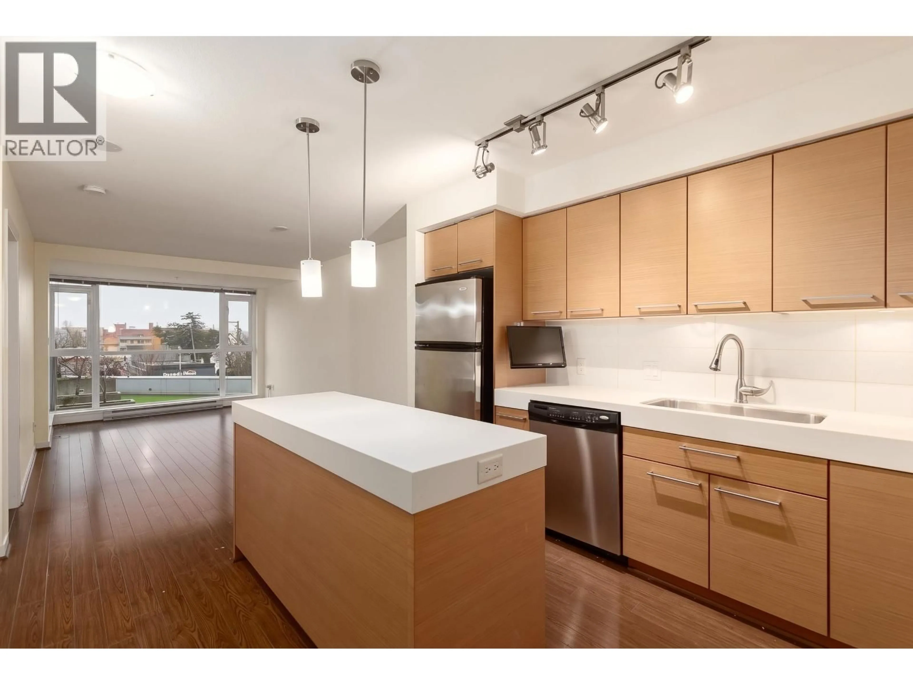 Open concept kitchen, wood/laminate floor for 408 - 2770 SOPHIA STREET, Vancouver British Columbia V5T0A4
