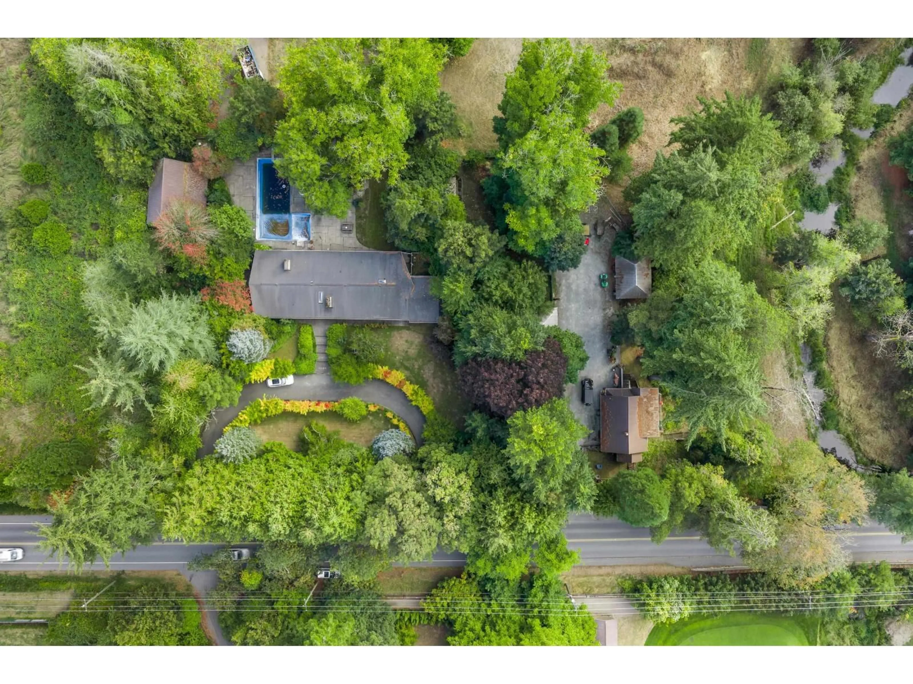 A pic from outside/outdoor area/front of a property/back of a property/a pic from drone, forest/trees view for 21180 48 AVENUE, Langley British Columbia V3A3M2