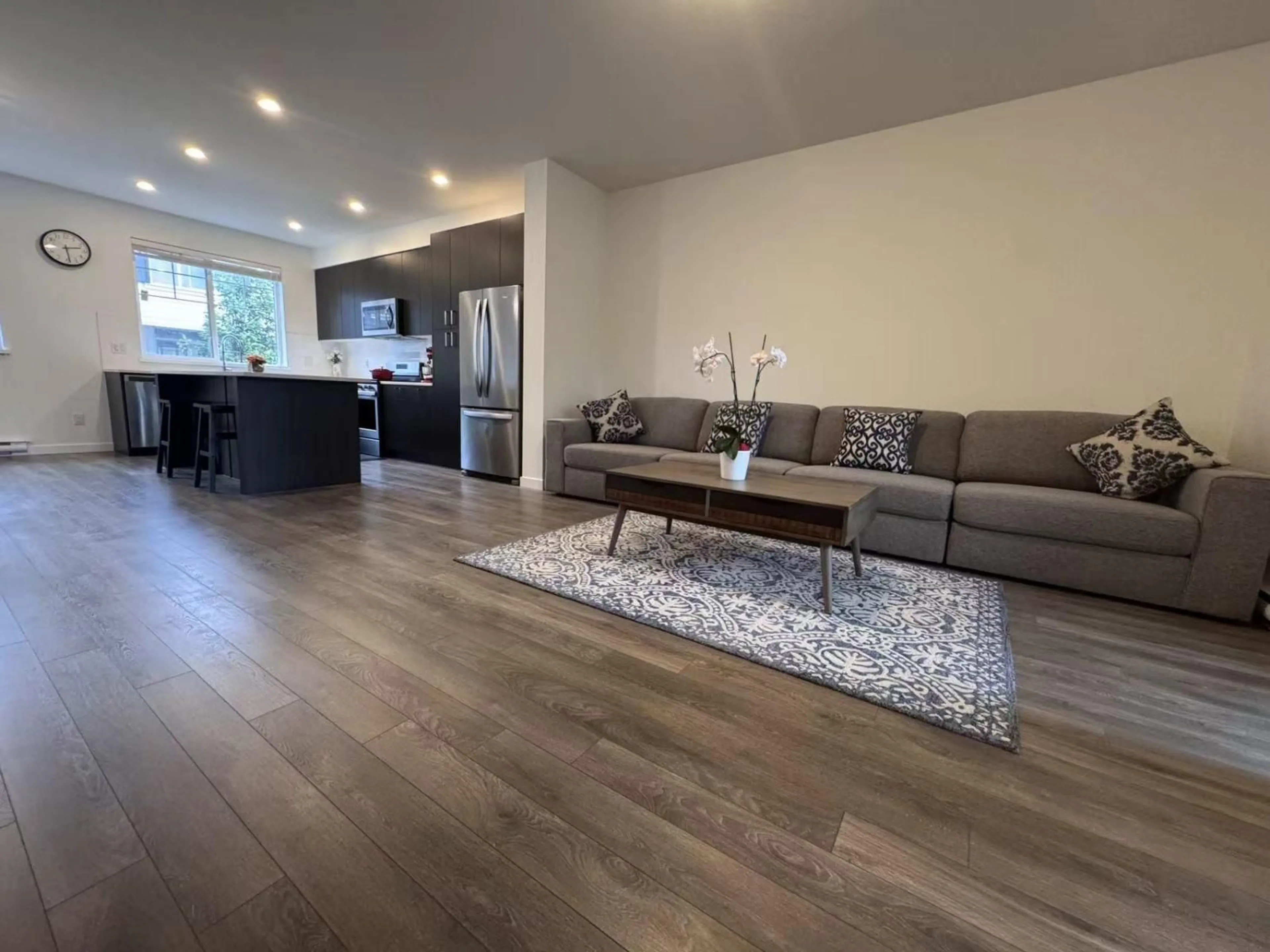 Living room with furniture, wood/laminate floor for 9 - 127 172 STREET, Surrey British Columbia V3Z0W9