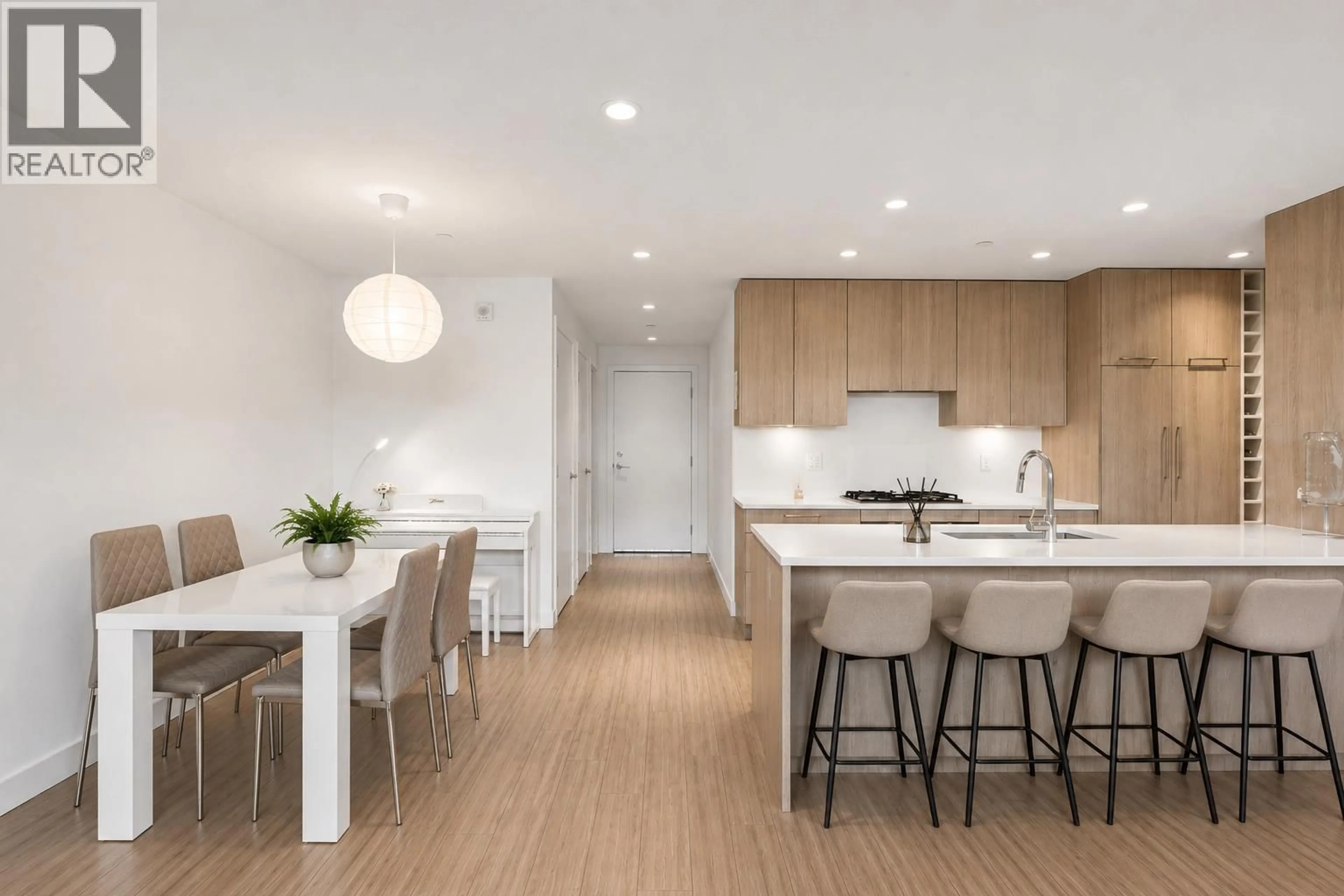 Open concept kitchen, wood/laminate floor for 203 - 747 3RD STREET, North Vancouver British Columbia V7L1G8
