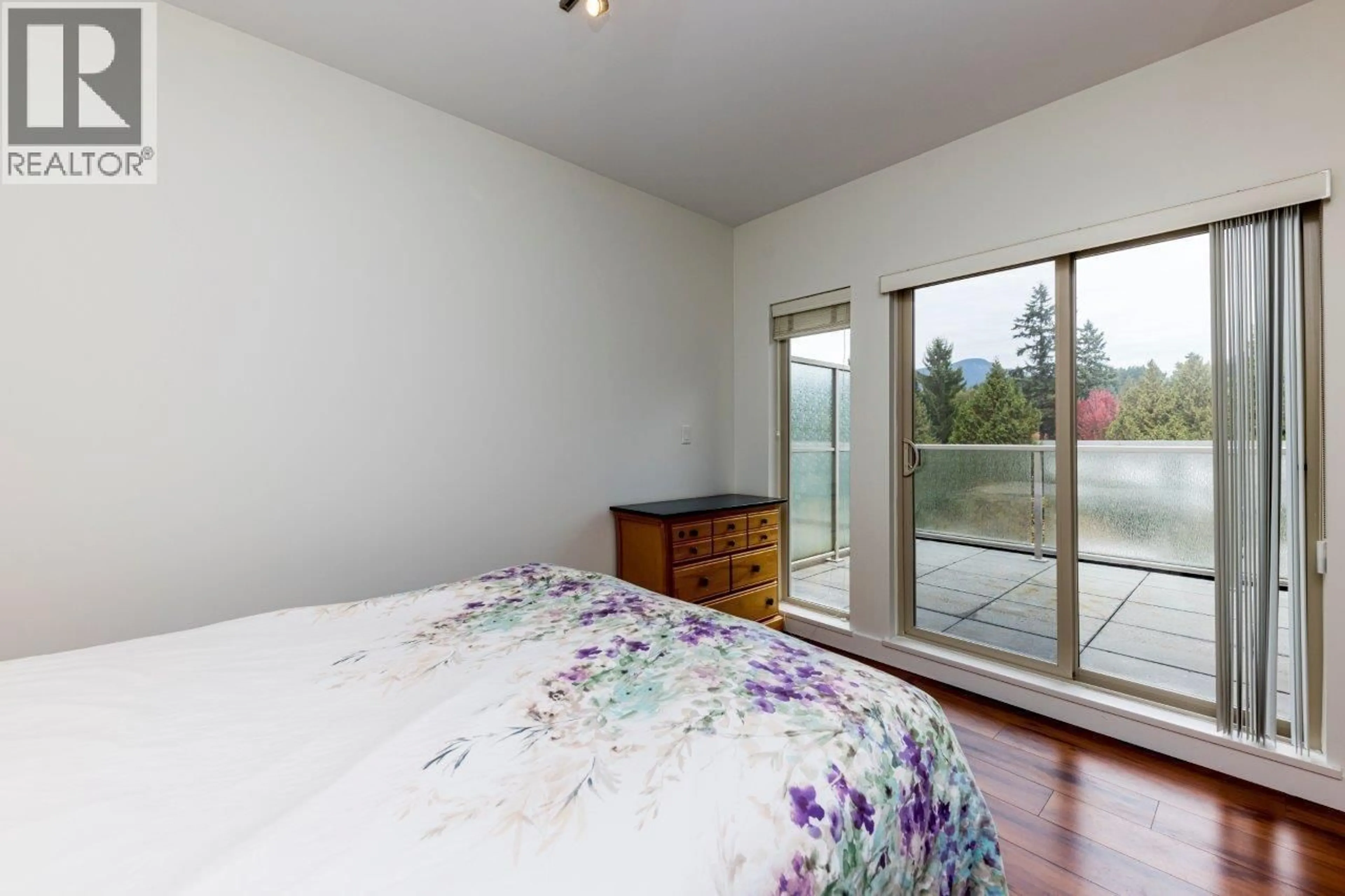 Bedroom with bed, wood/laminate floor for 402 - 2138 OLD DOLLARTON ROAD, North Vancouver British Columbia V7H1A7