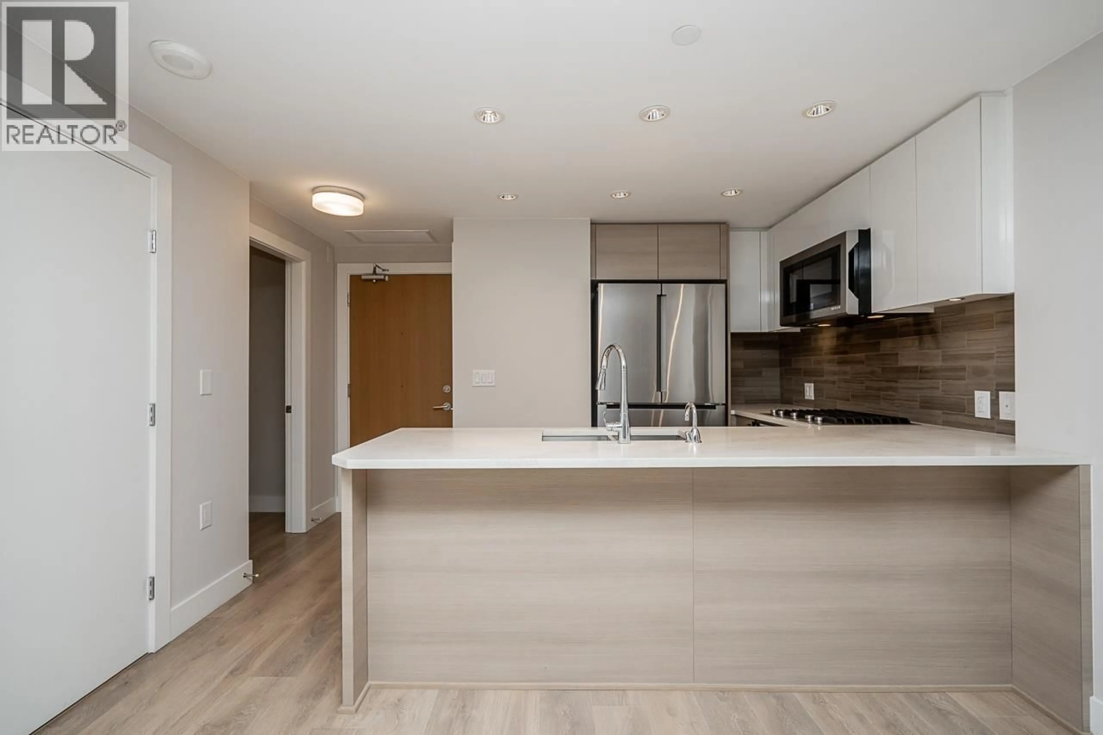 Open concept kitchen, wood/laminate floor for 310 - 3451 SAWMILL CRESCENT, Vancouver British Columbia V5S0H3