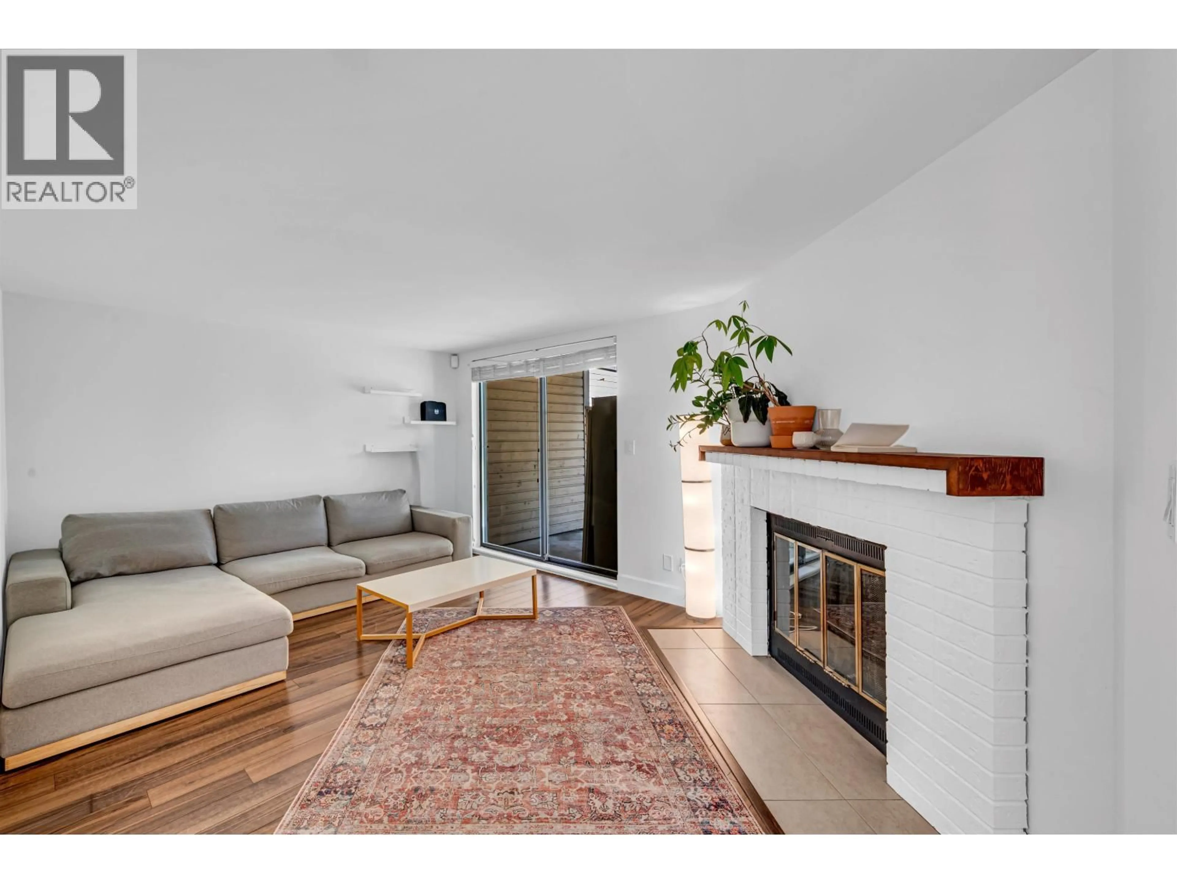 Living room with furniture, wood/laminate floor for 7237 QUATSINO DRIVE, Vancouver British Columbia V5S4C2