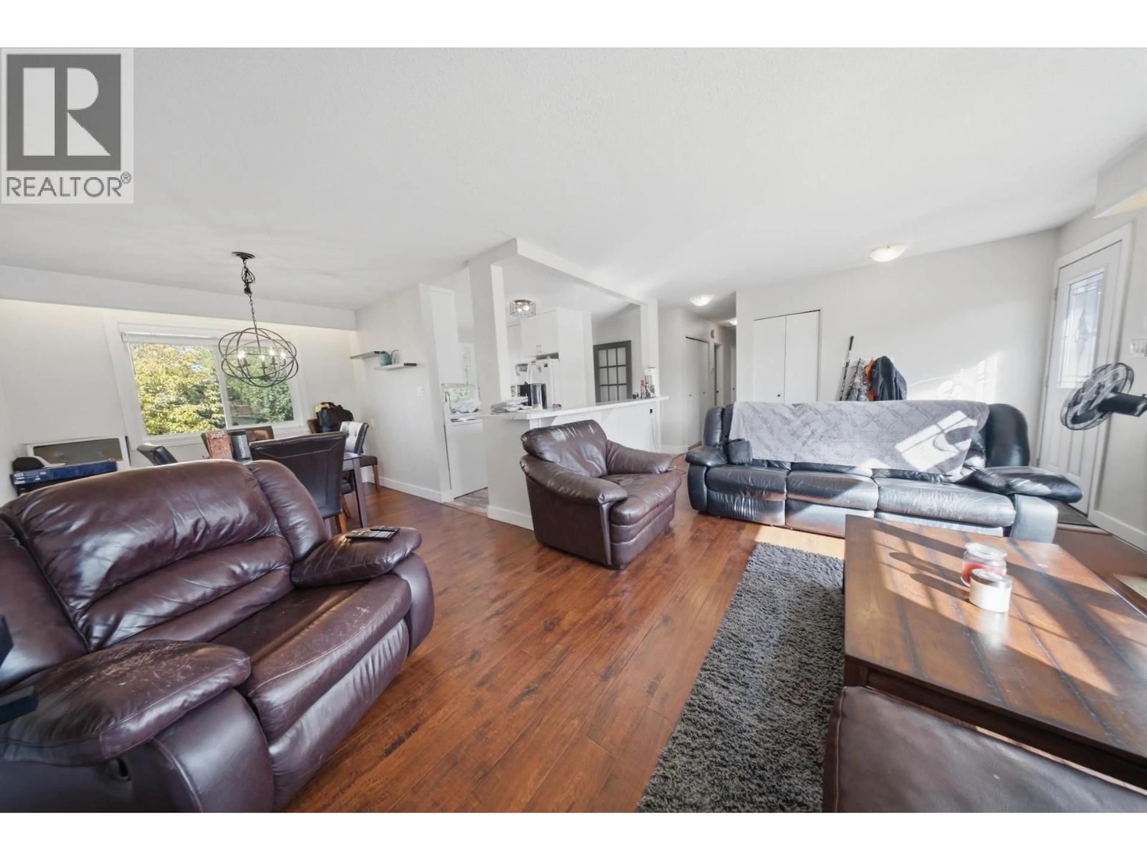 Living room with furniture, wood/laminate floor for 10404 112 AVENUE, Fort St. John British Columbia V1J2W7
