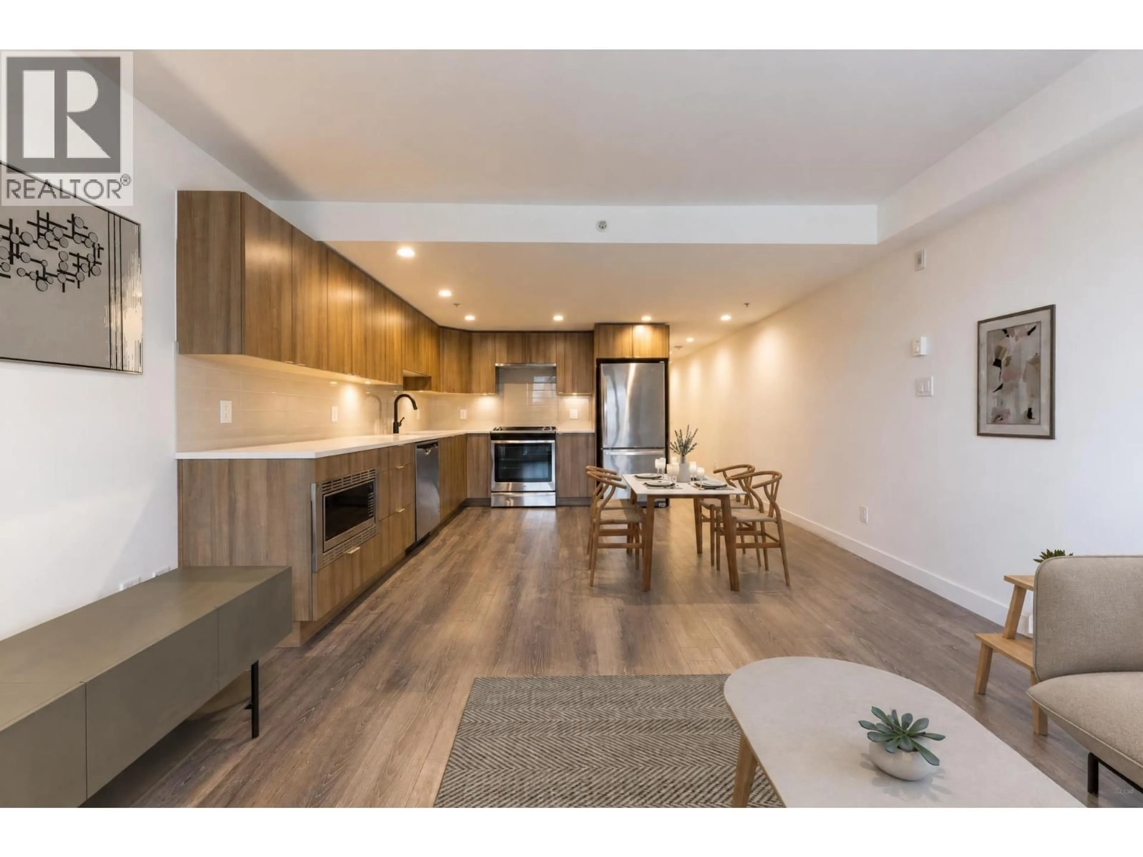Open concept kitchen, wood/laminate floor for 403 - 1365 PEMBERTON AVENUE, Squamish British Columbia V8B1B7