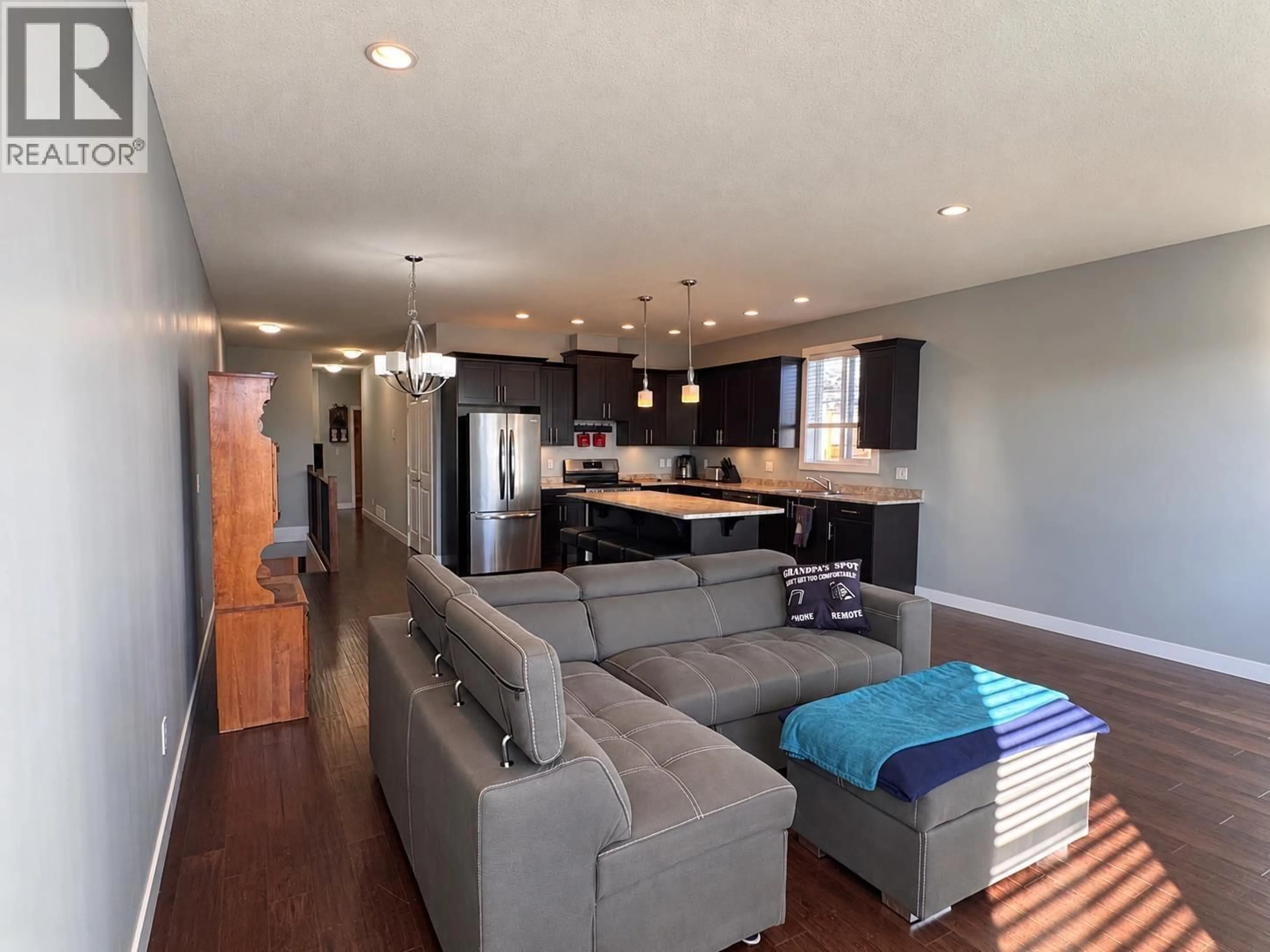 Living room with furniture, wood/laminate floor for 8211 96 AVENUE, Fort St. John British Columbia V1J1J7