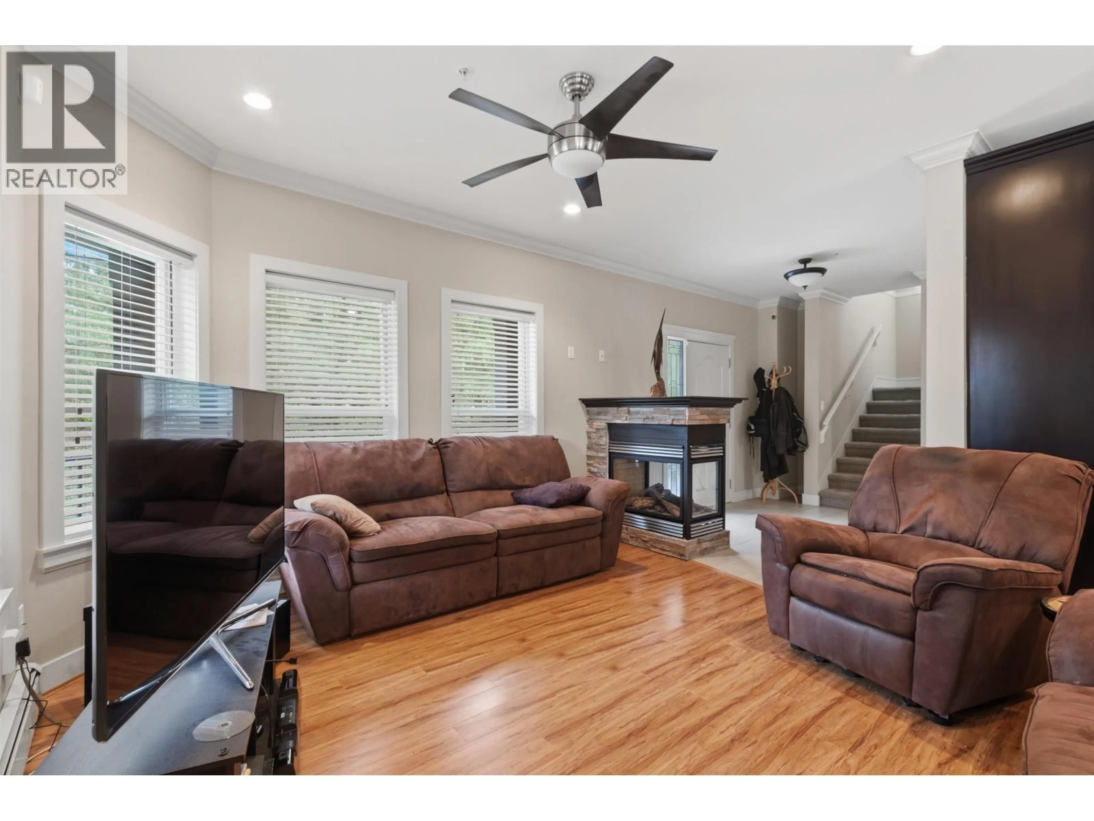 Living room with furniture, wood/laminate floor for 24230 104 AVENUE, Maple Ridge British Columbia V2W0E4