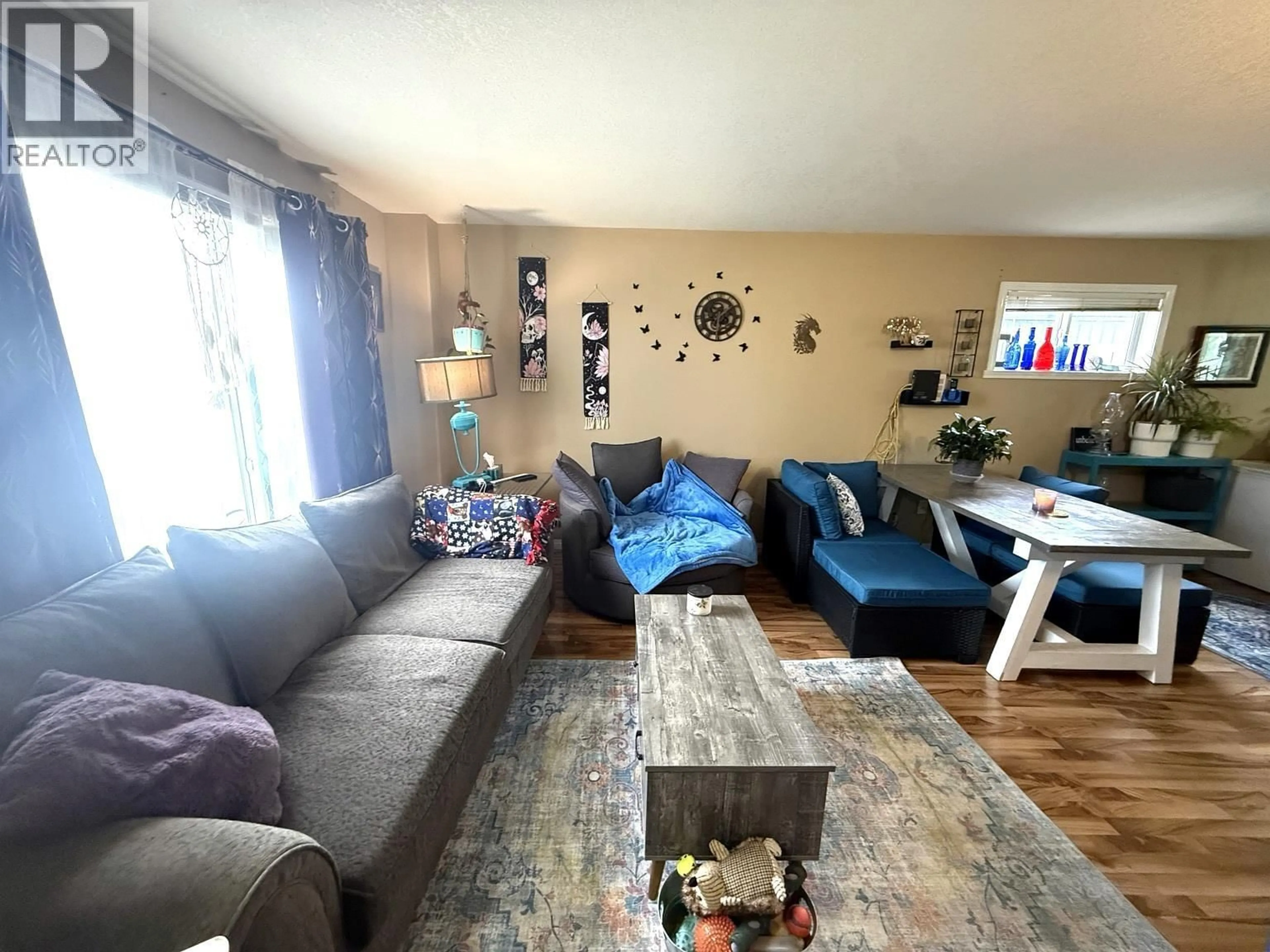 Living room with furniture, wood/laminate floor for 11119 101 AVENUE, Fort St. John British Columbia V1J2C4