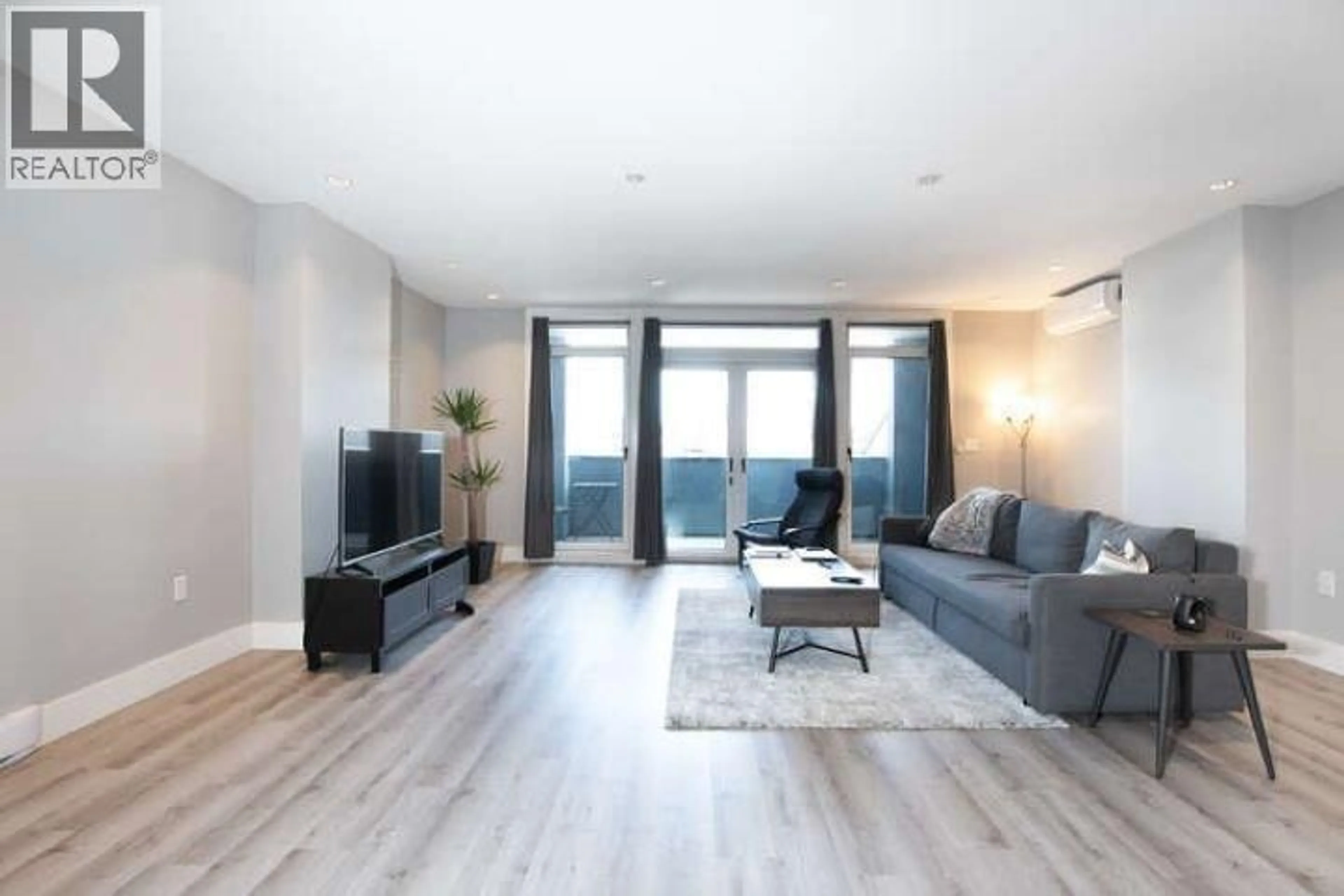 Living room with furniture, wood/laminate floor for 102 - 4876 DELTA STREET, Delta British Columbia V4K2T8