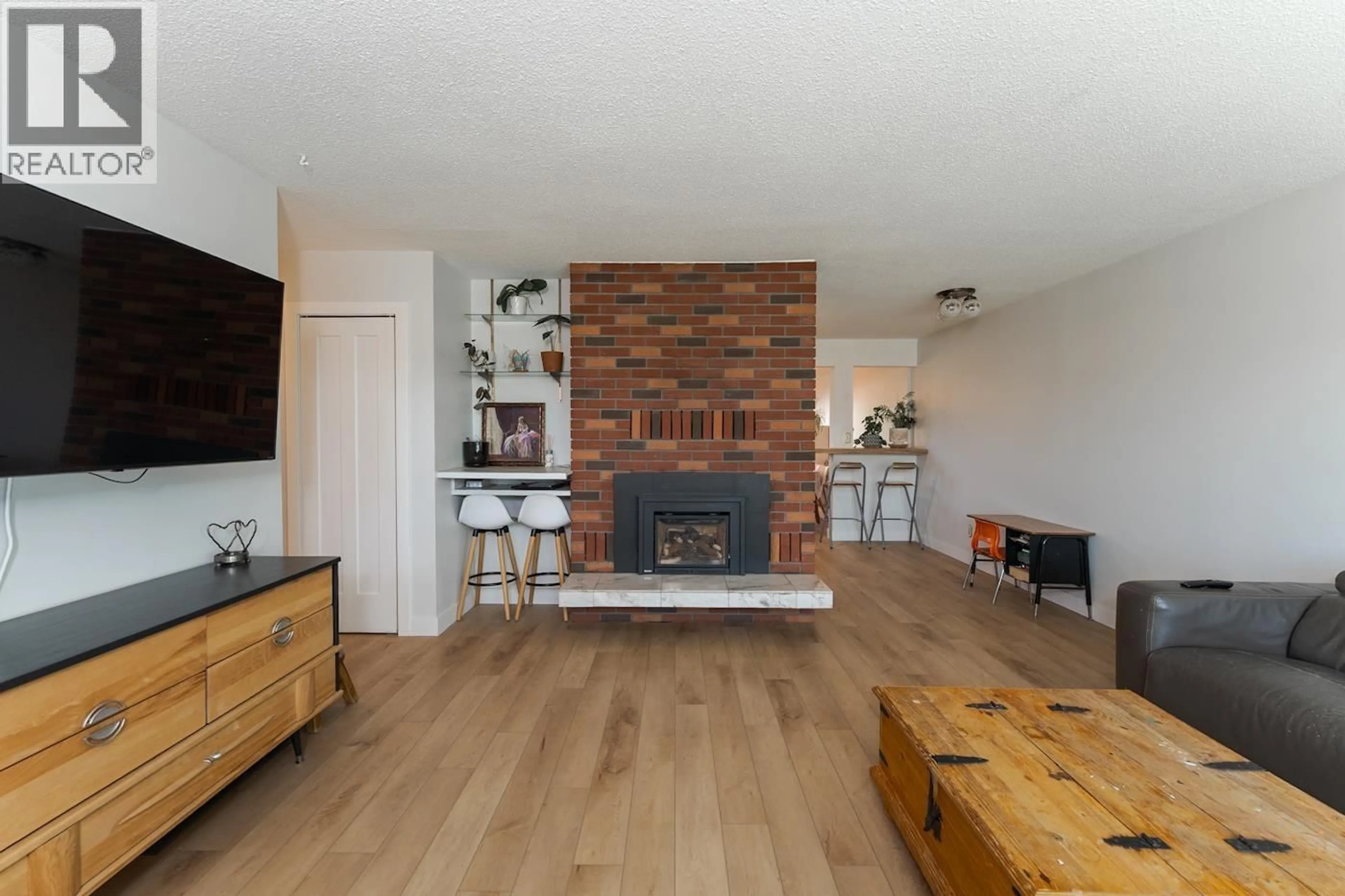 Living room with furniture, wood/laminate floor for 8805 CHILCOTIN ROAD, Prince George British Columbia V2N5V9