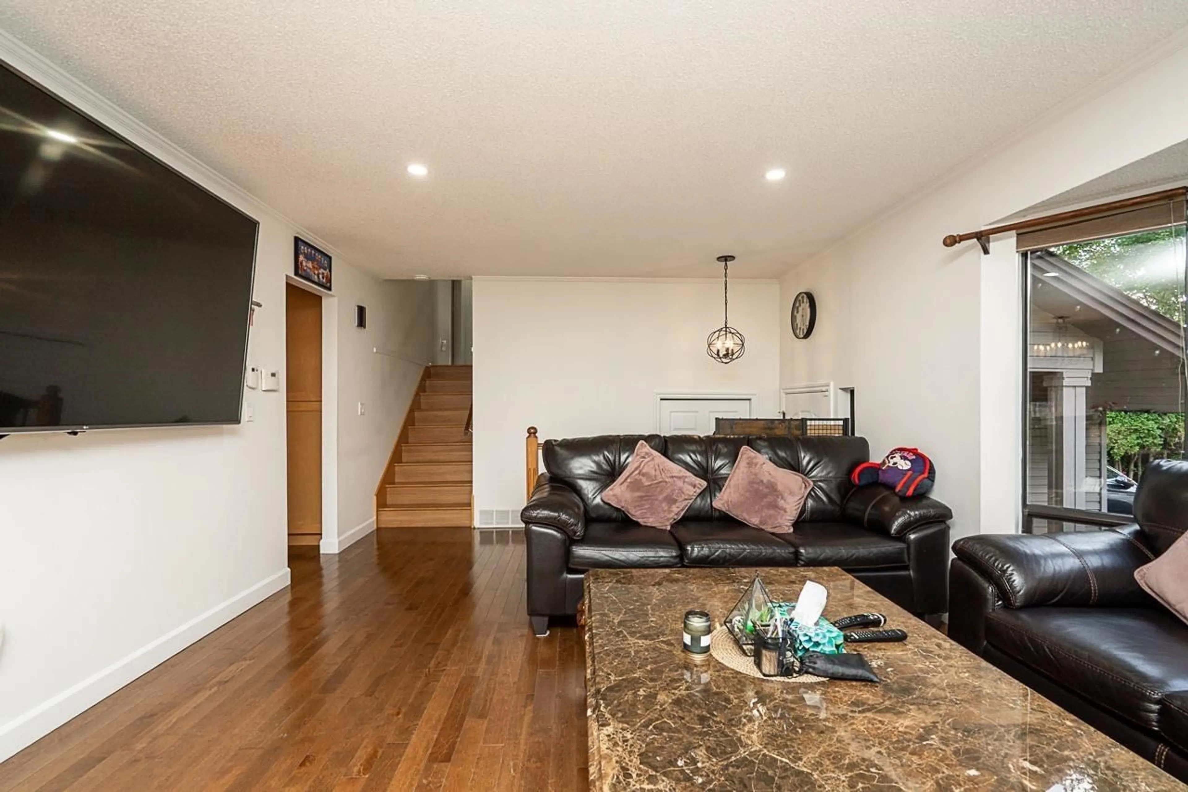 Living room with furniture, wood/laminate floor for 8448 154 STREET, Surrey British Columbia V3S6H3