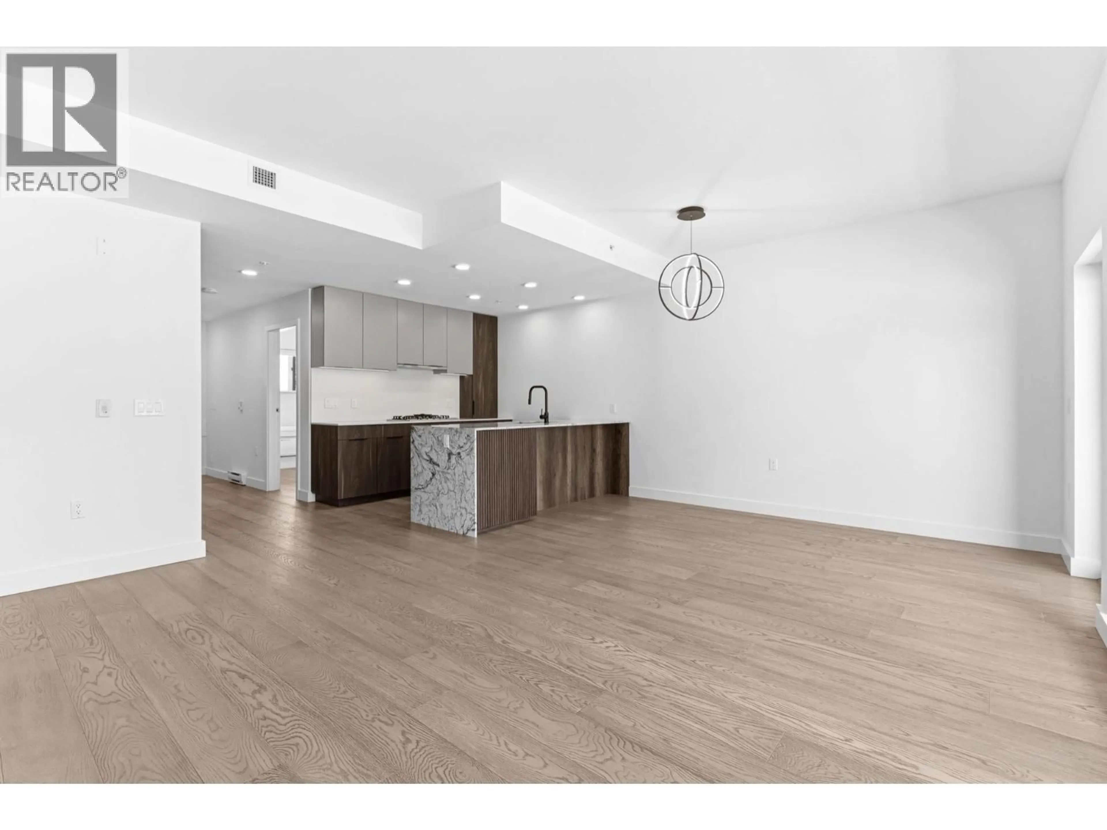 Open concept kitchen, wood/laminate floor for 202 - 3590 39TH AVENUE, Vancouver British Columbia V6N3A5