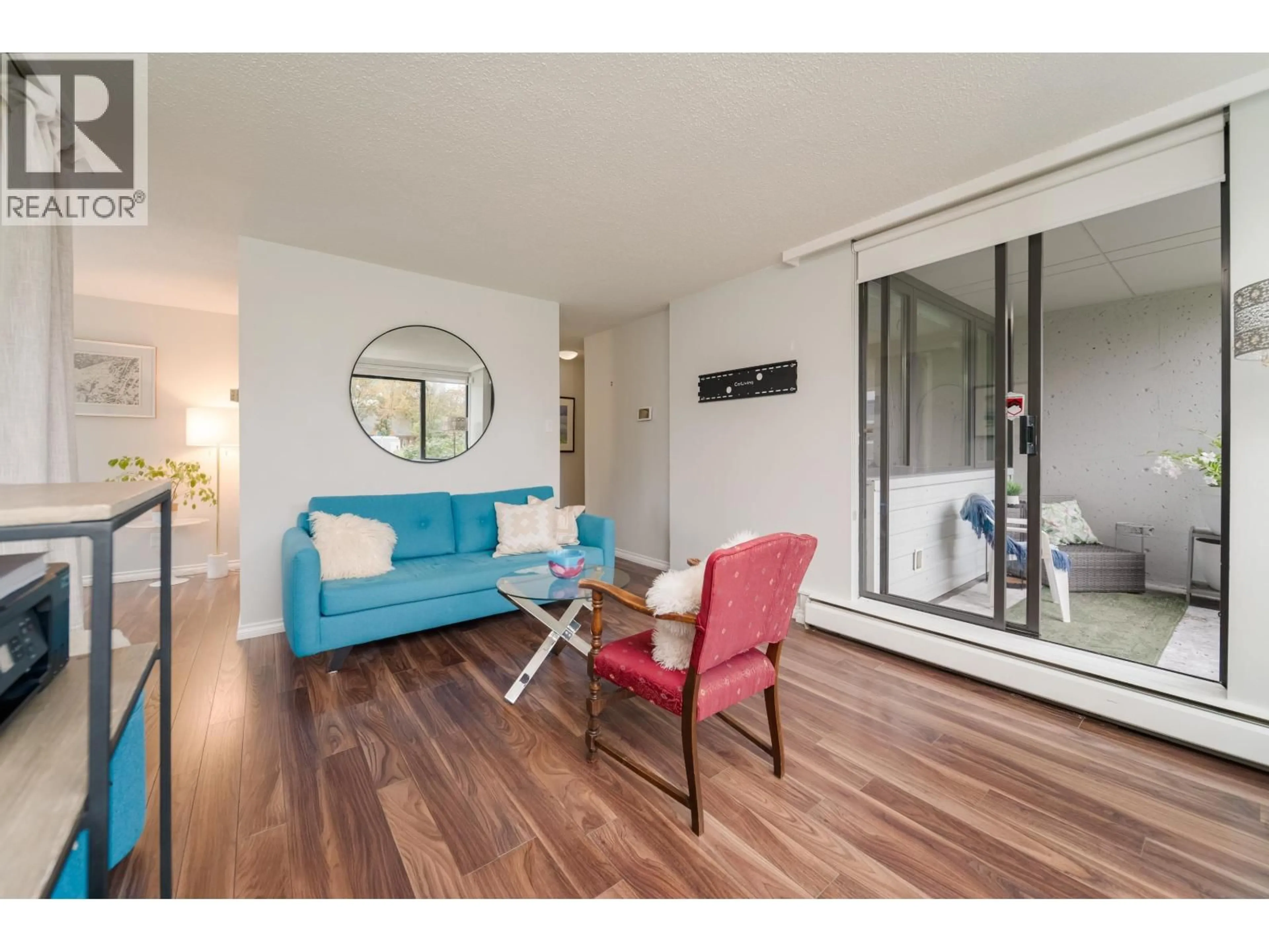 Living room with furniture, wood/laminate floor for 206 - 1740 COMOX STREET, Vancouver British Columbia V6G2Z1