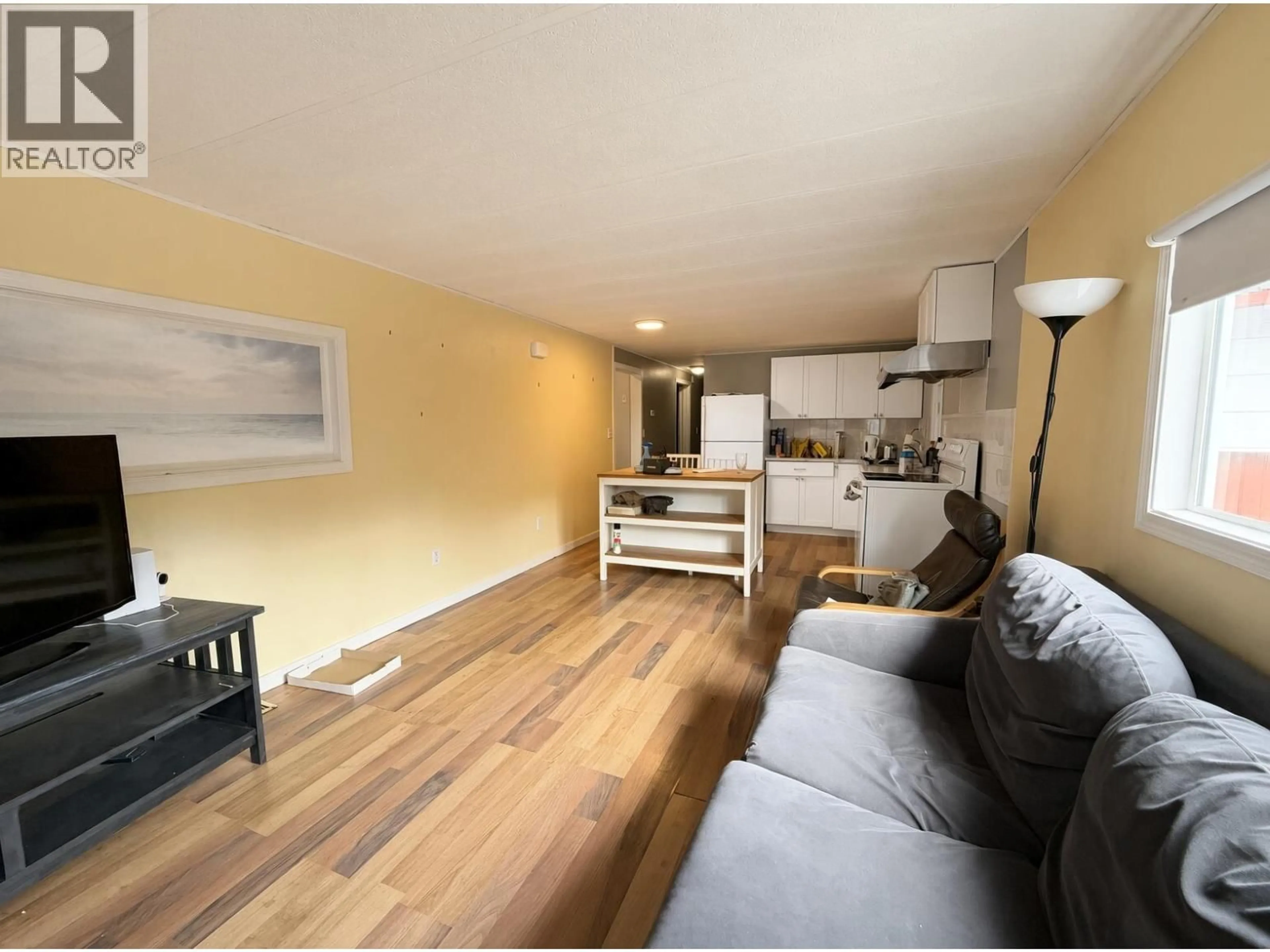 Living room with furniture, wood/laminate floor for 49 4200 DEWDNEY TRUNK ROAD, Coquitlam British Columbia V3H3E2