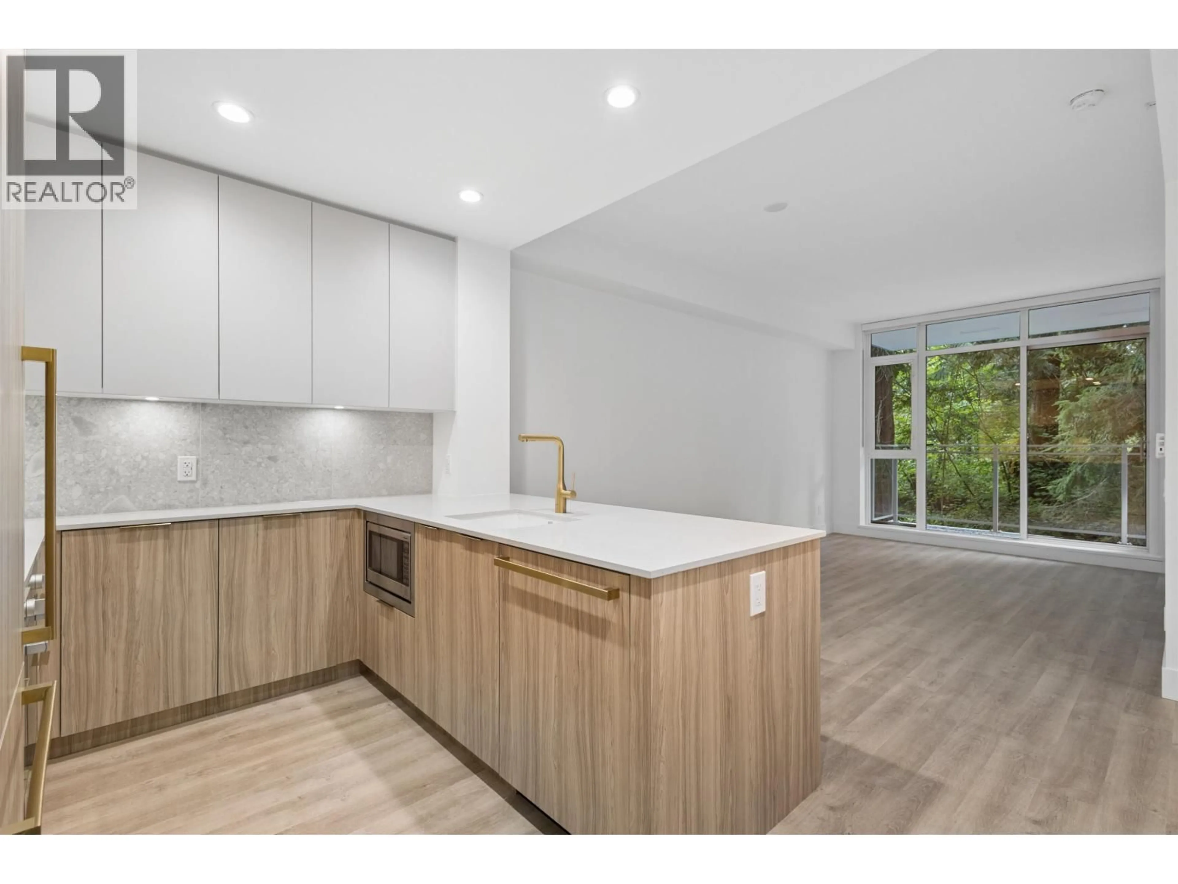 Open concept kitchen, wood/laminate floor for 208 - 2375 EMERY COURT, North Vancouver British Columbia V7J0E8
