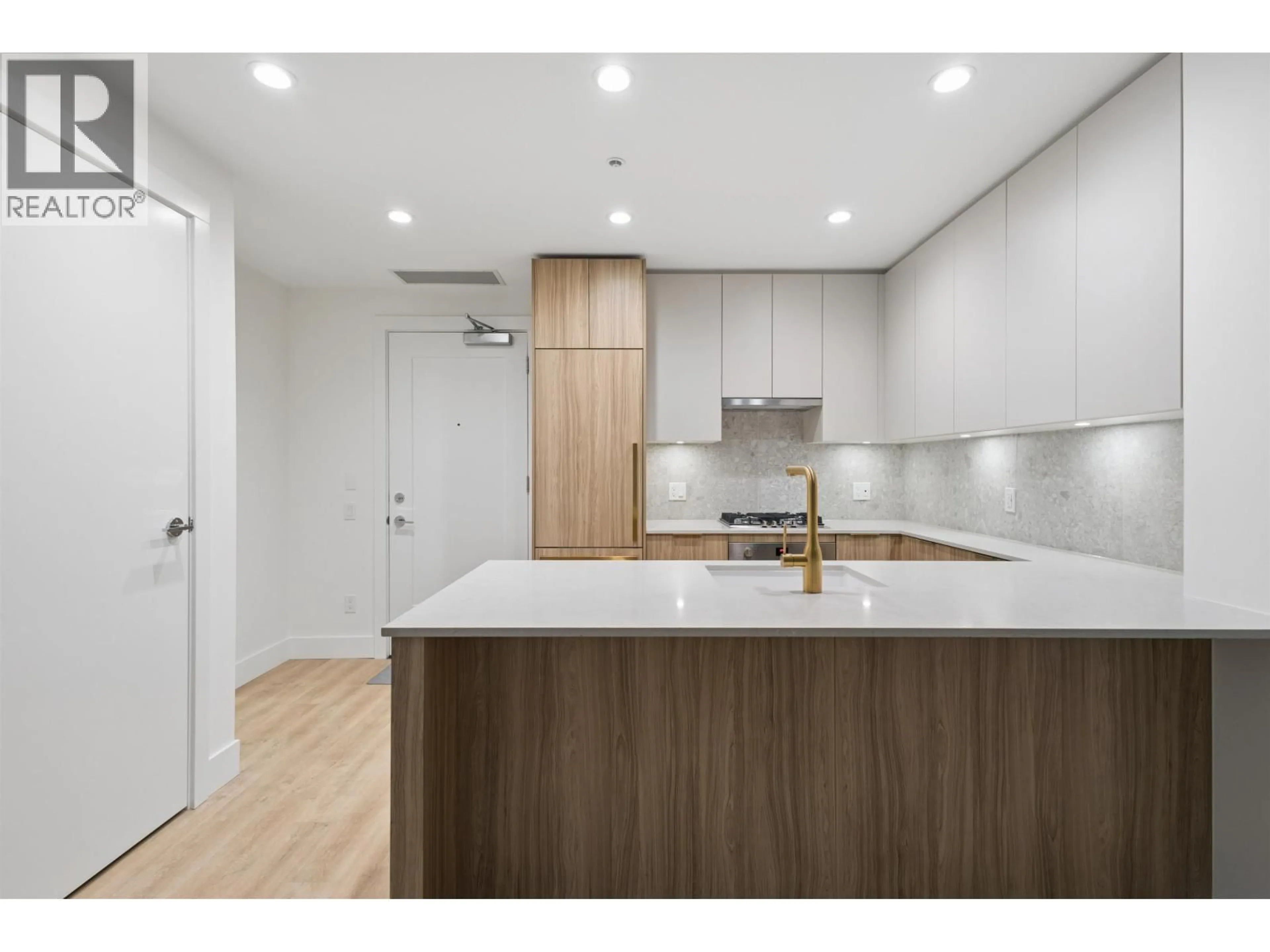 Open concept kitchen, wood/laminate floor for 208 - 2375 EMERY COURT, North Vancouver British Columbia V7J0E8