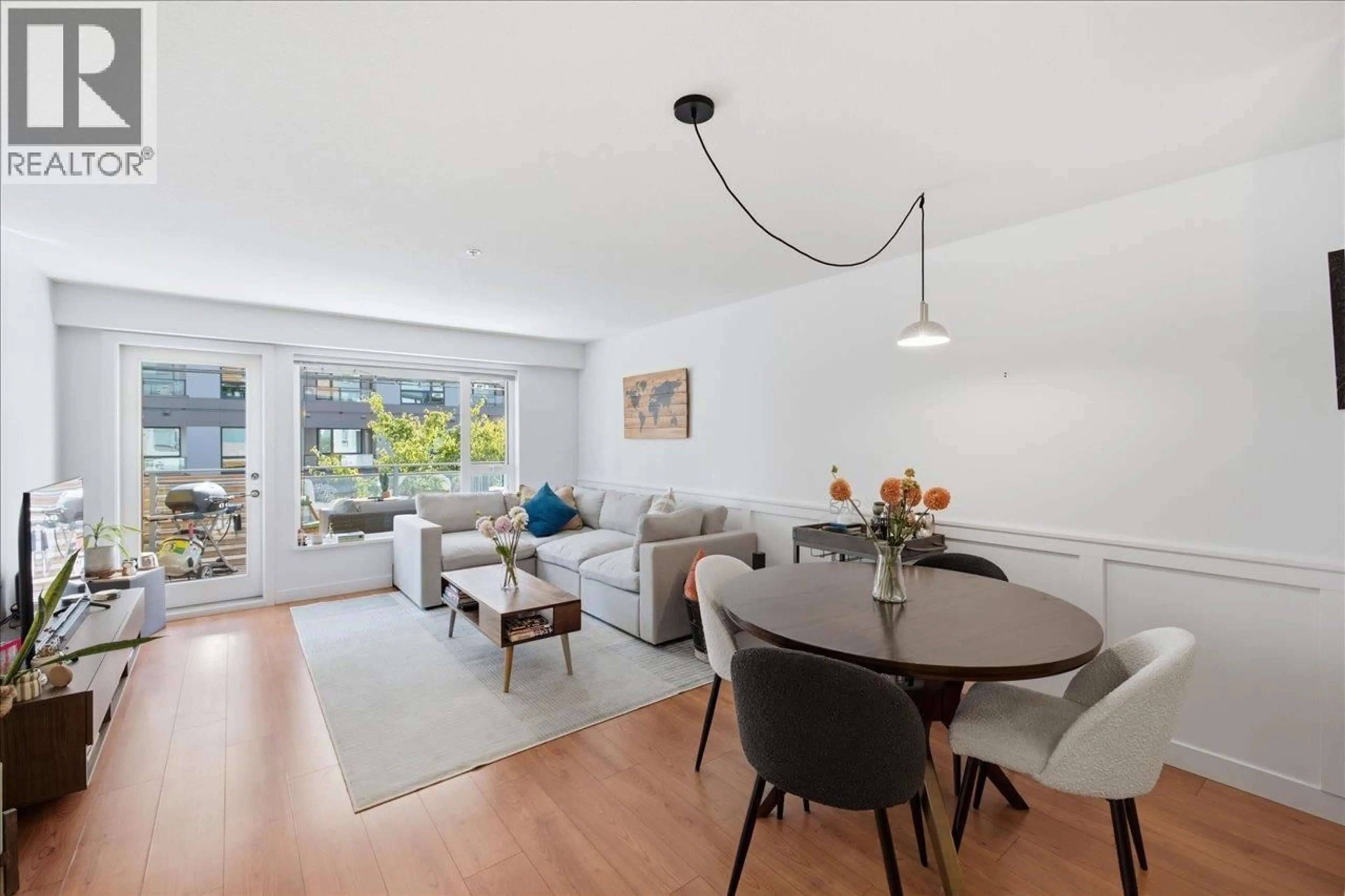Living room with furniture, wood/laminate floor for 102 - 221 3RD STREET, North Vancouver British Columbia V7L0C1