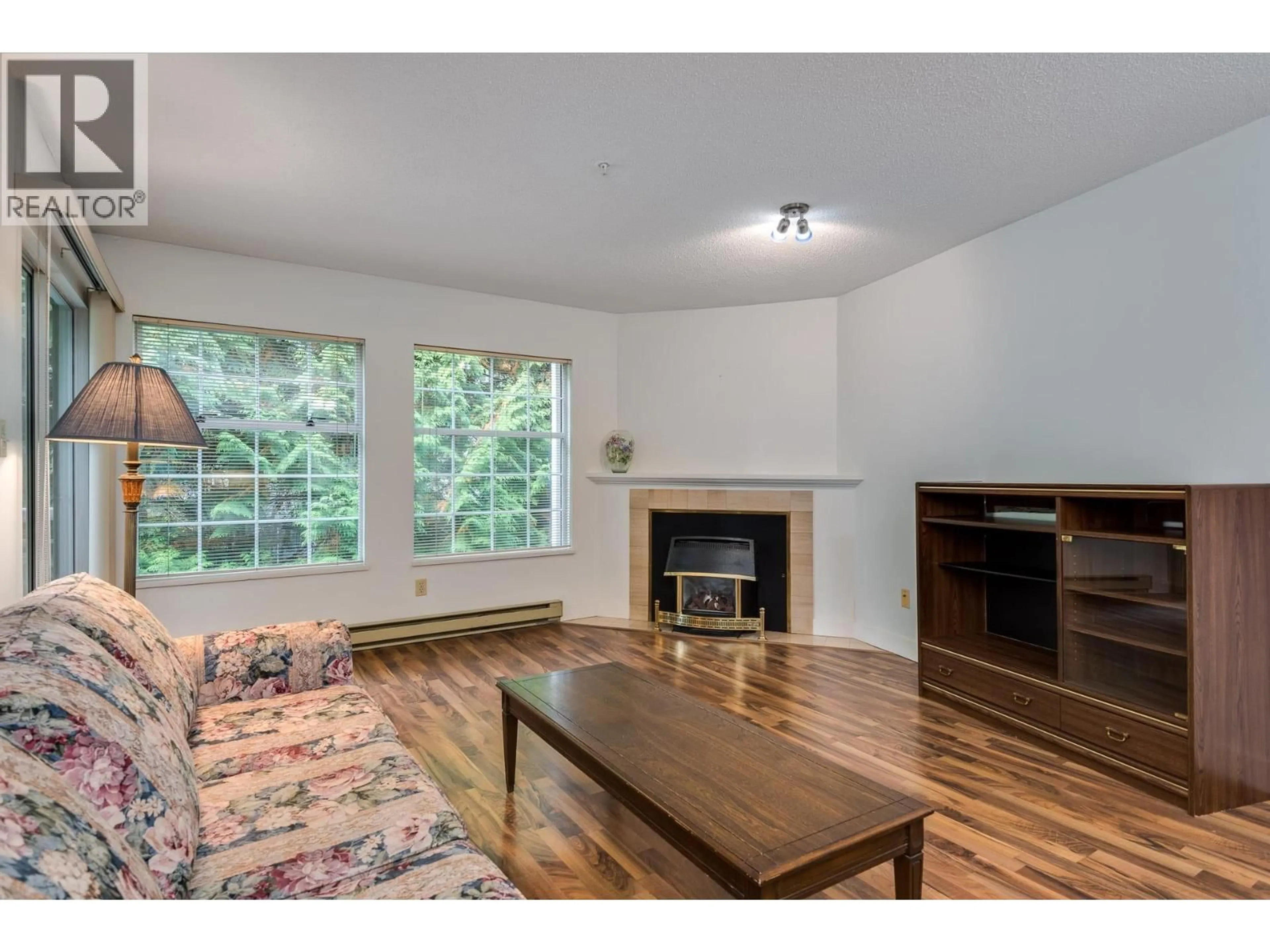 Living room with furniture, wood/laminate floor for 303 - 2963 BURLINGTON DRIVE, Coquitlam British Columbia V3B6X1
