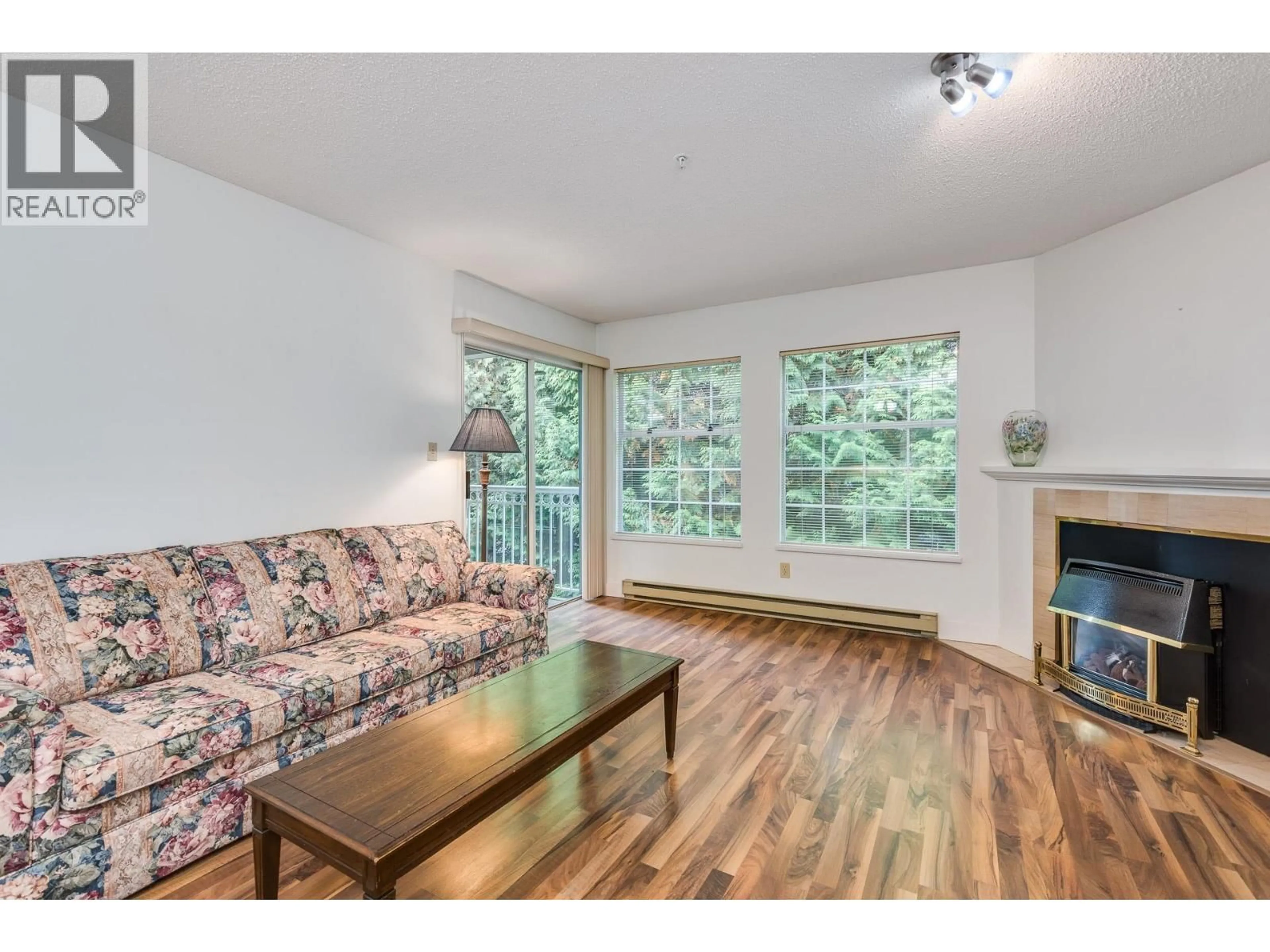 Living room with furniture, wood/laminate floor for 303 - 2963 BURLINGTON DRIVE, Coquitlam British Columbia V3B6X1