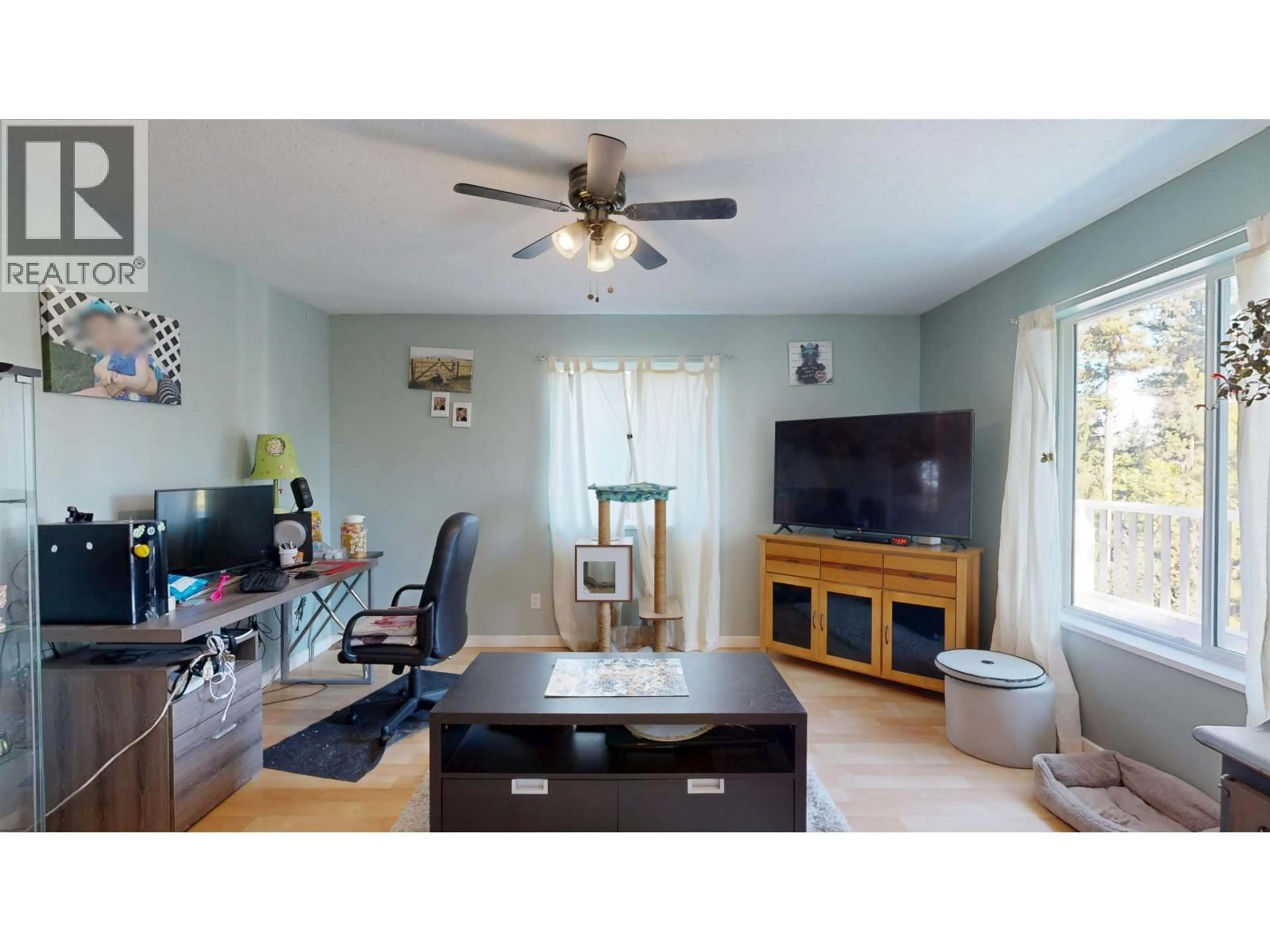 Living room with furniture, wood/laminate floor for 4871 STEWART ROAD, 100 Mile House British Columbia V0K2Z0