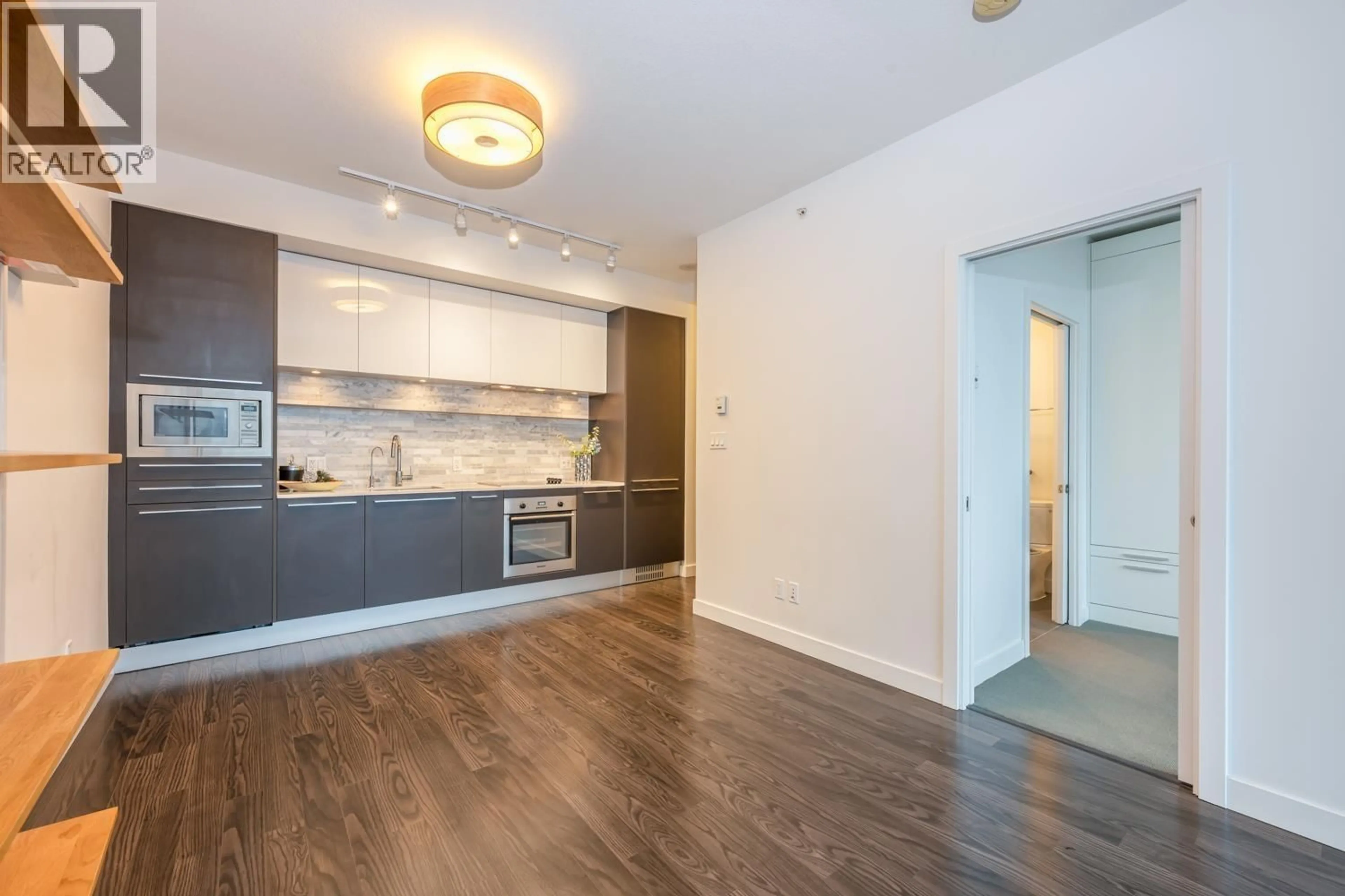 Open concept kitchen, wood/laminate floor for 2406 - 8031 NUNAVUT LANE, Vancouver British Columbia V5X0C9