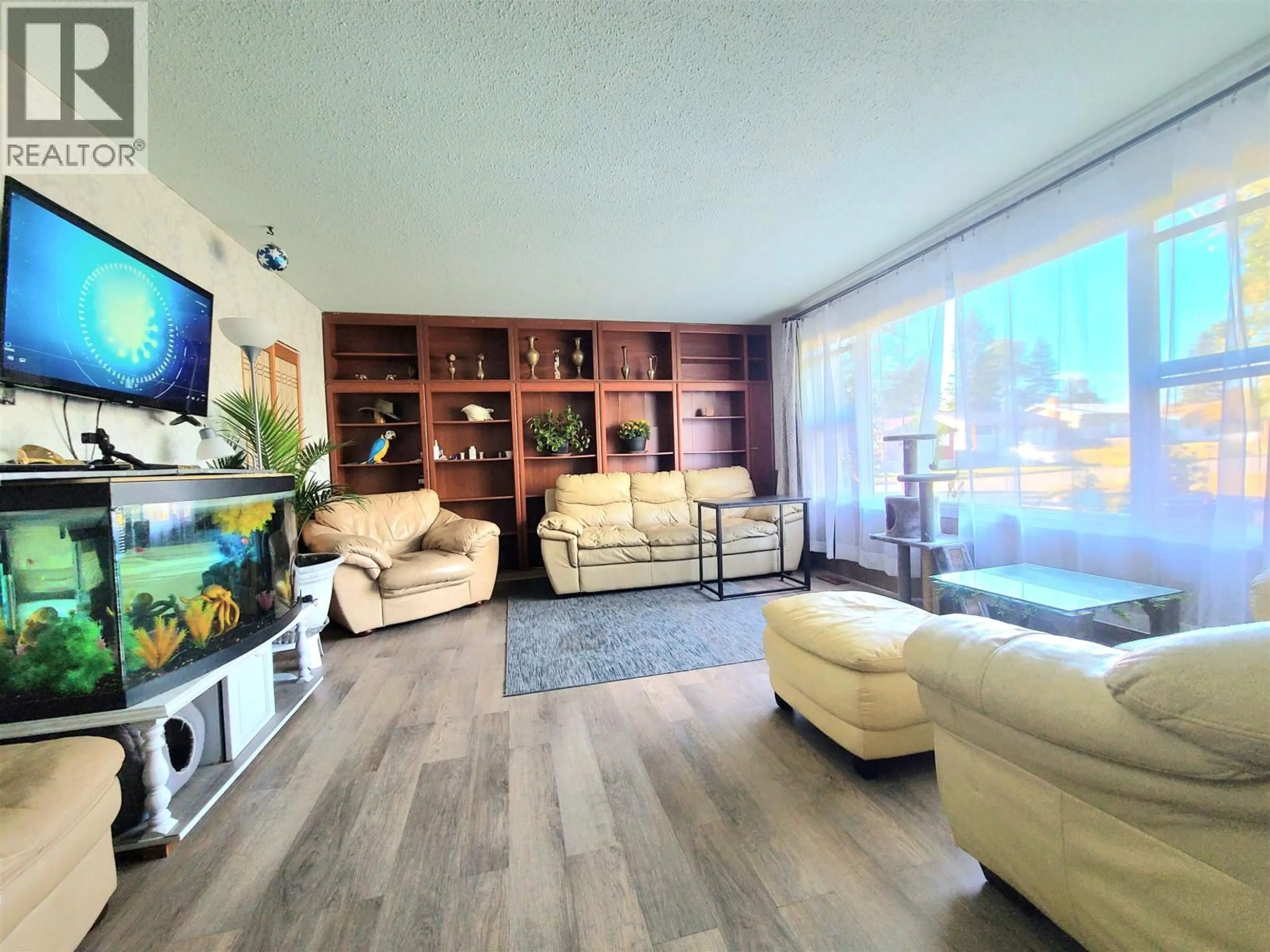 Living room with furniture, wood/laminate floor for 1385 MILBURN AVENUE, Prince George British Columbia V2L4E9