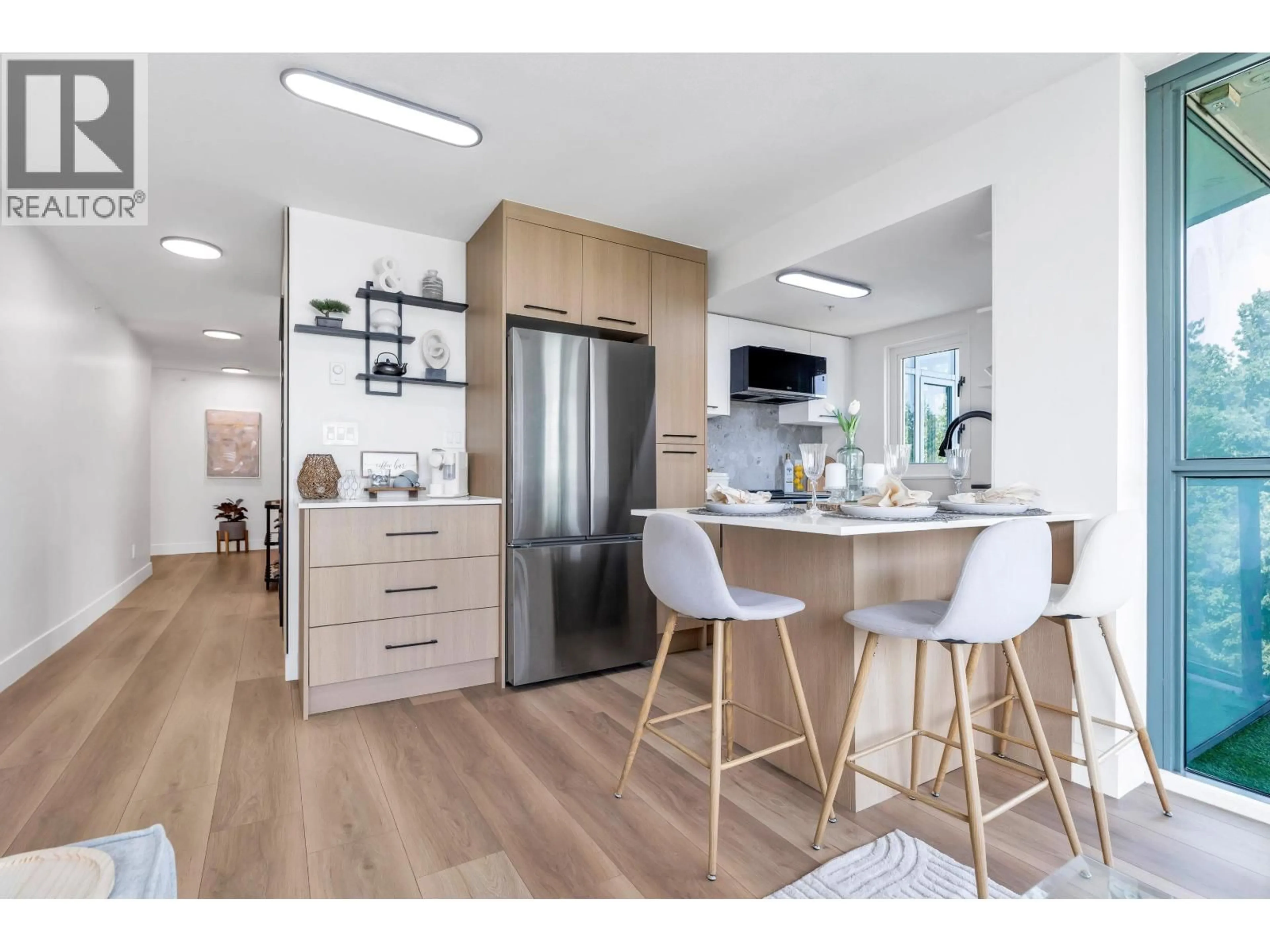 Open concept kitchen, wood/laminate floor for 1001 - 2733 CHANDLERY PLACE, Vancouver British Columbia V5S4V3