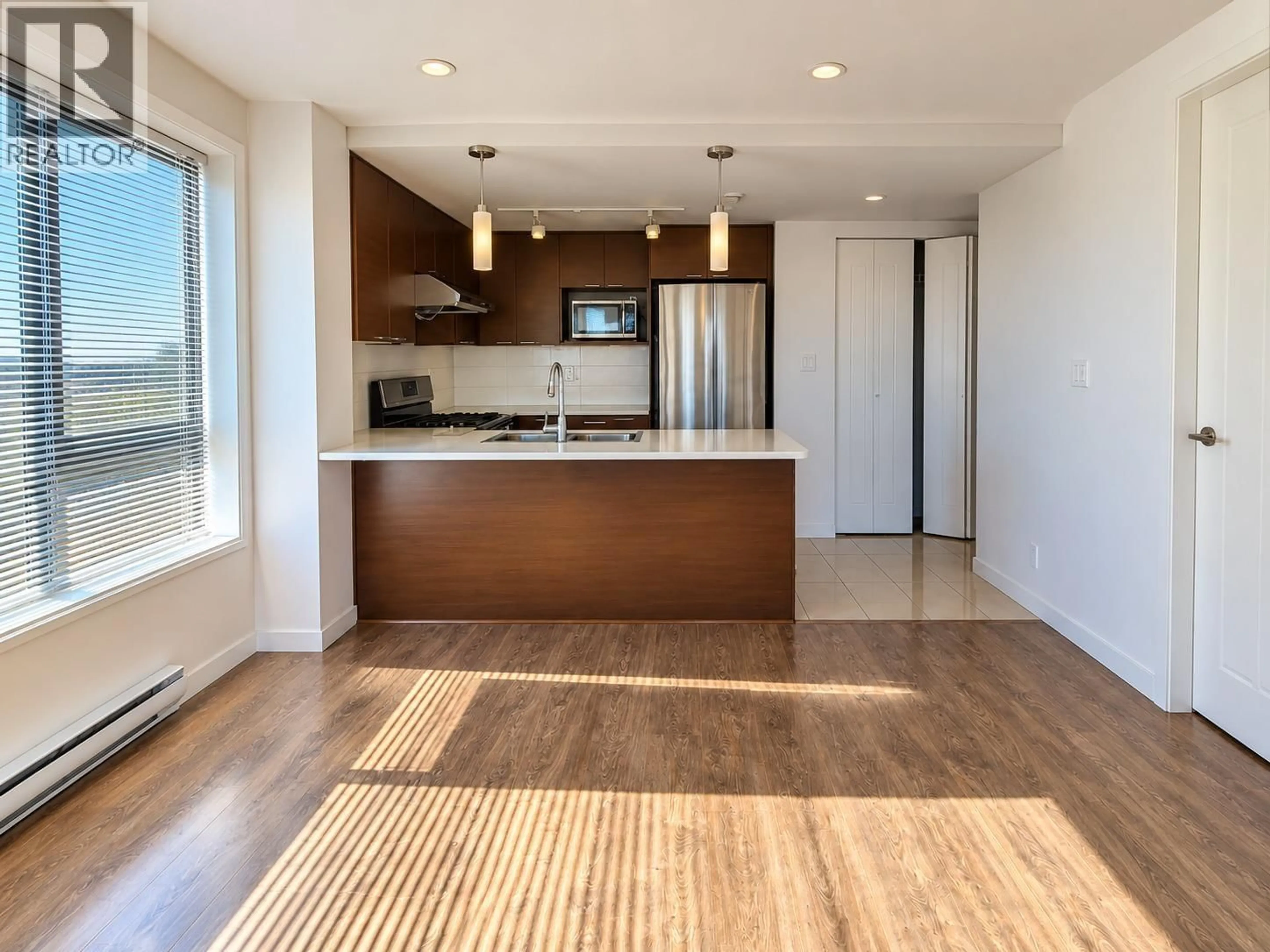 Open concept kitchen, wood/laminate floor for 327 - 10880 NO. 5 ROAD, Richmond British Columbia V6W0B3
