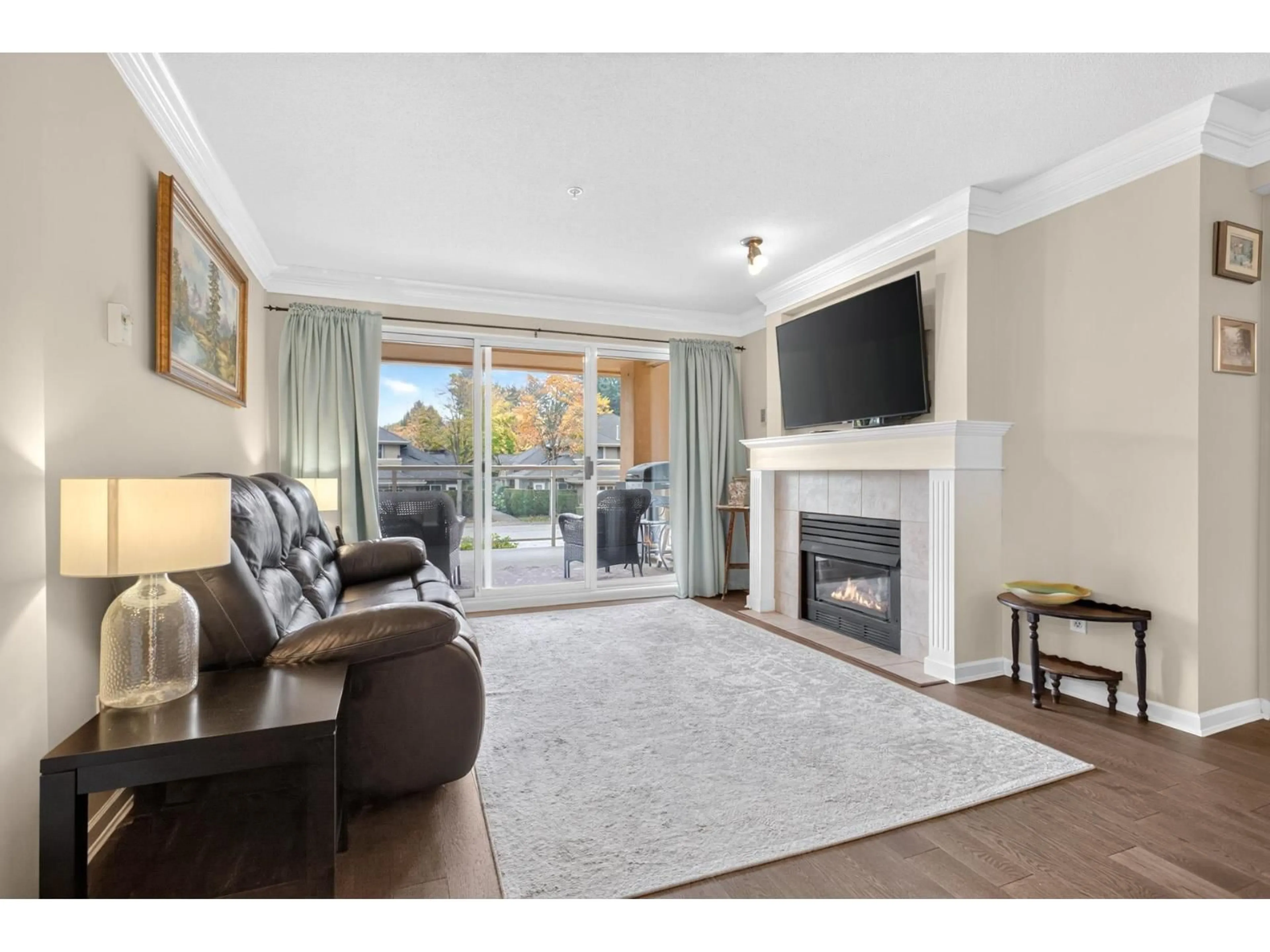 Living room with furniture, wood/laminate floor for 208 - 15155 22 AVENUE, Surrey British Columbia V4A9T4
