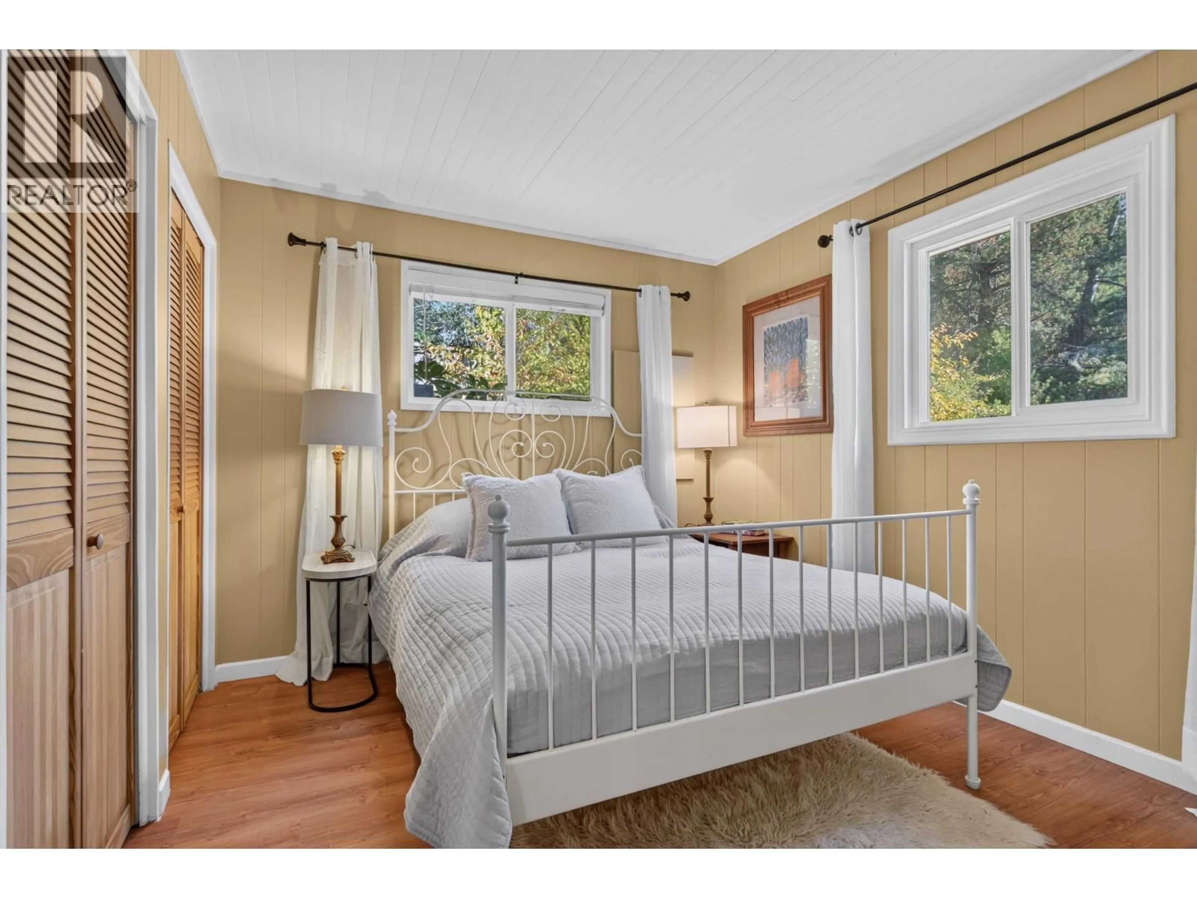 Bedroom with bed, wood/laminate floor for 130 BOOTH CANAL ROAD, Salt Spring Island British Columbia V8K2N3