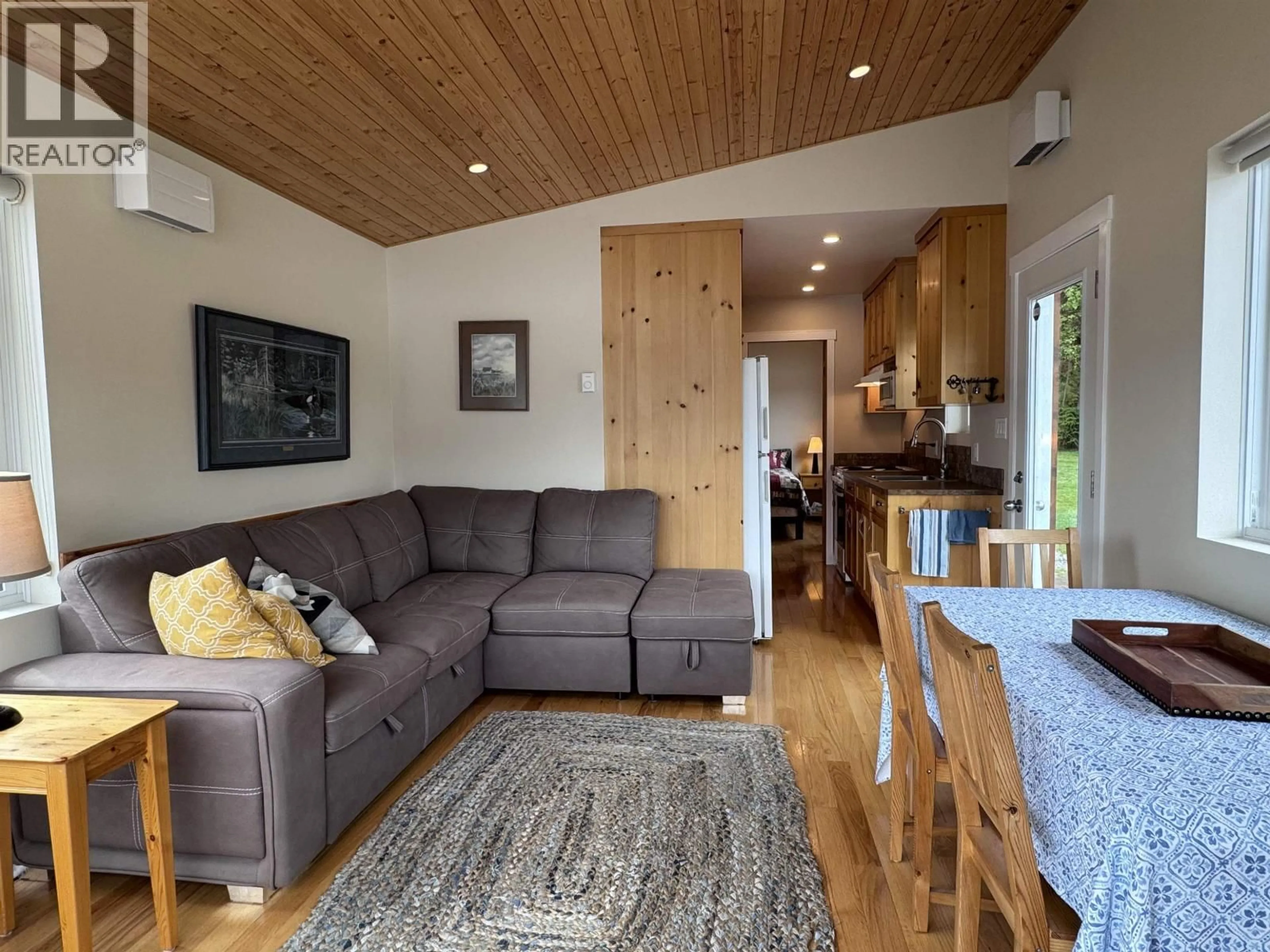 Living room with furniture, wood/laminate floor for 1440 WESTSIDE ROAD, Terrace British Columbia V8G4B8