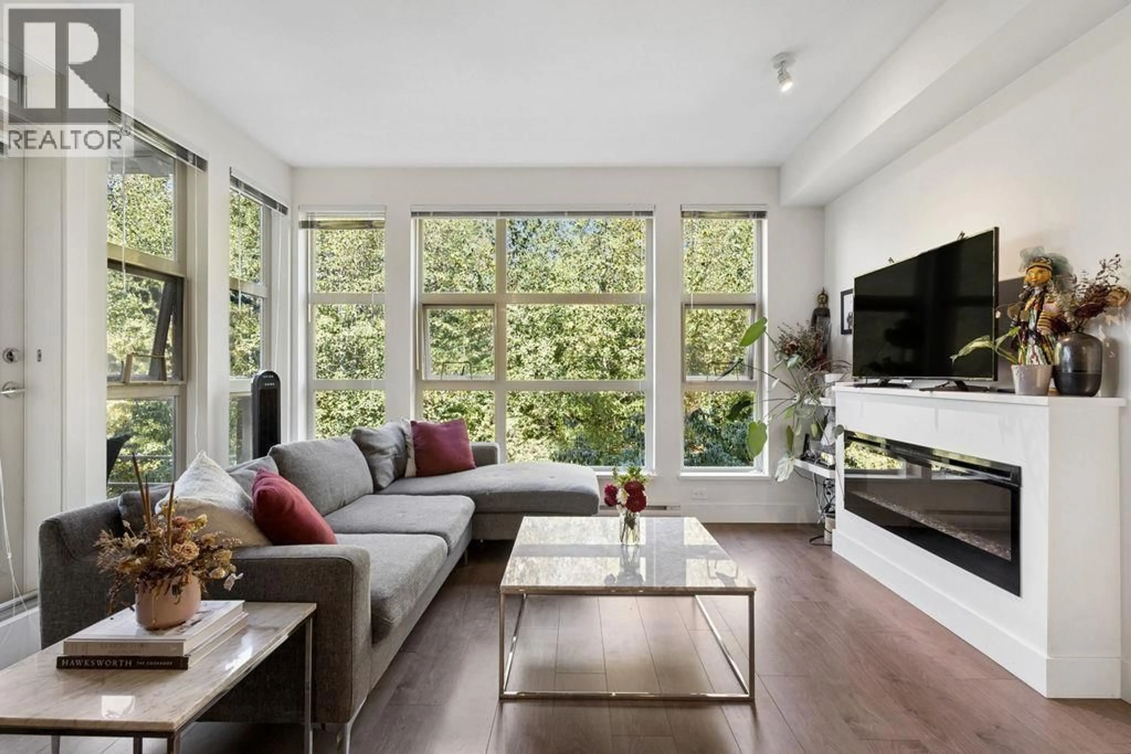 Living room with furniture, wood/laminate floor for 316 - 3602 ALDERCREST DRIVE, North Vancouver British Columbia V7G0A2
