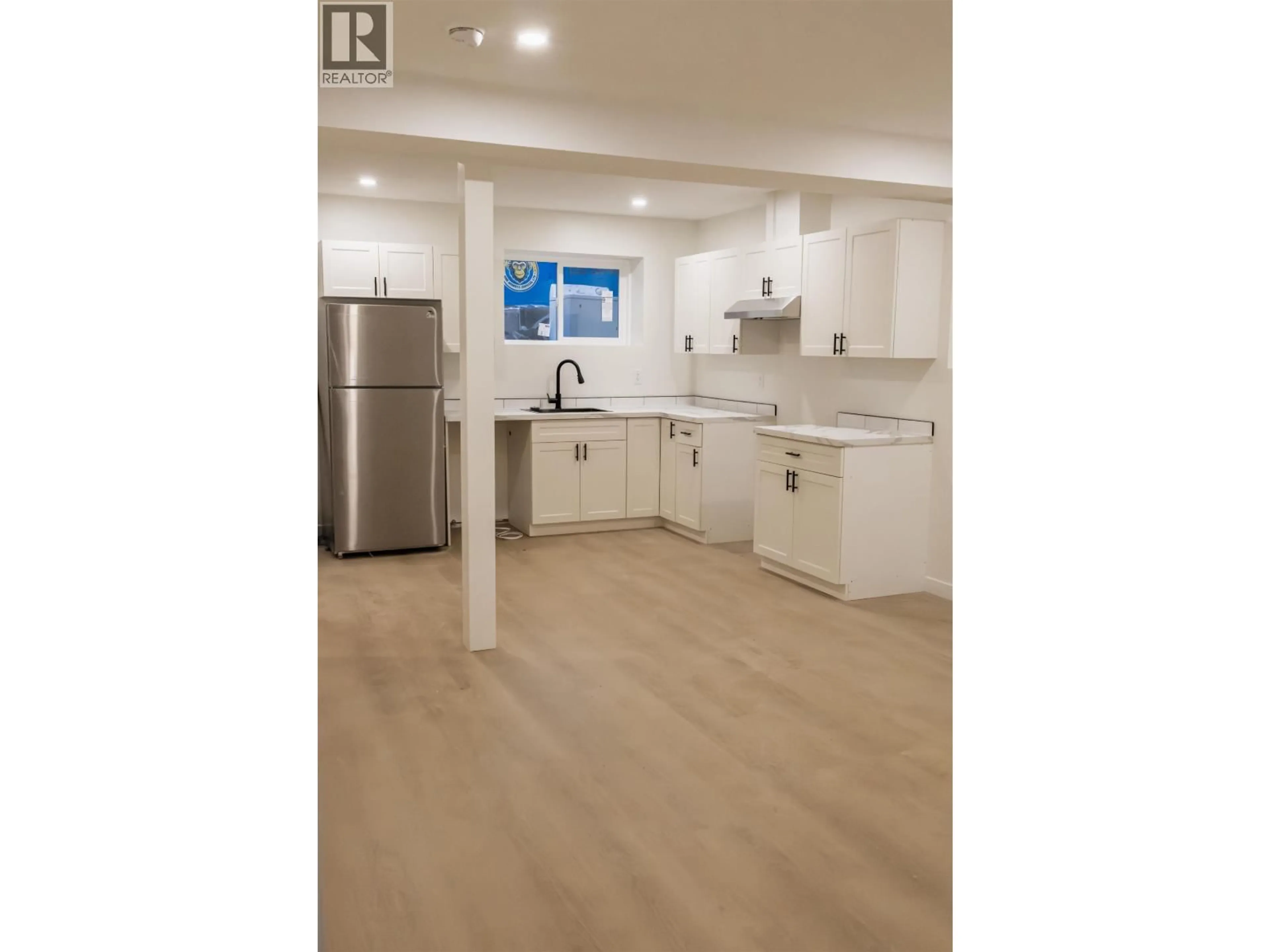 Open concept kitchen, wood/laminate floor for 2260 VICTORIA STREET, Prince George British Columbia V2L2L9