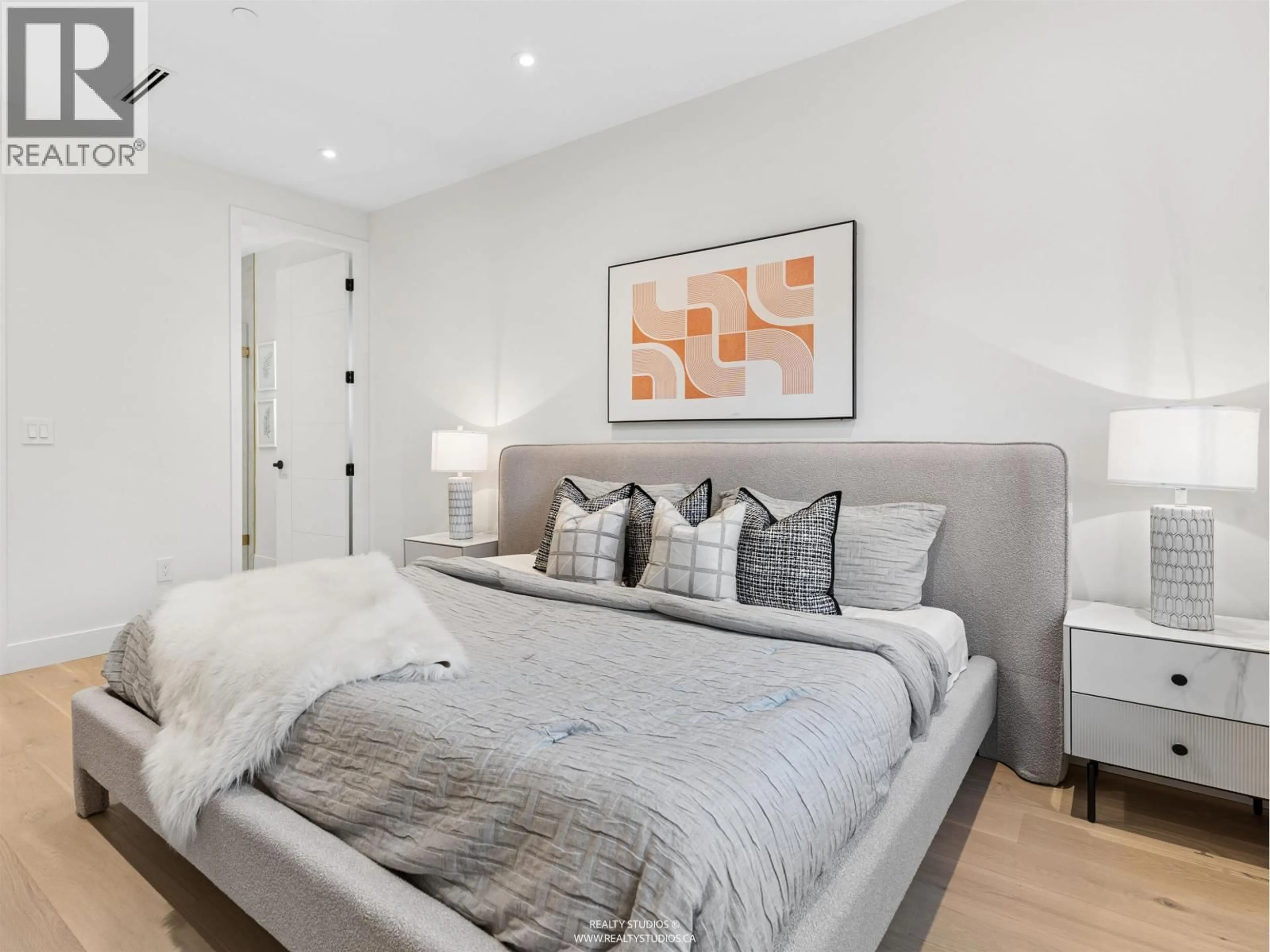 Bedroom with bed, wood/laminate floor for 2543 2ND AVENUE, Vancouver British Columbia V5T4C1