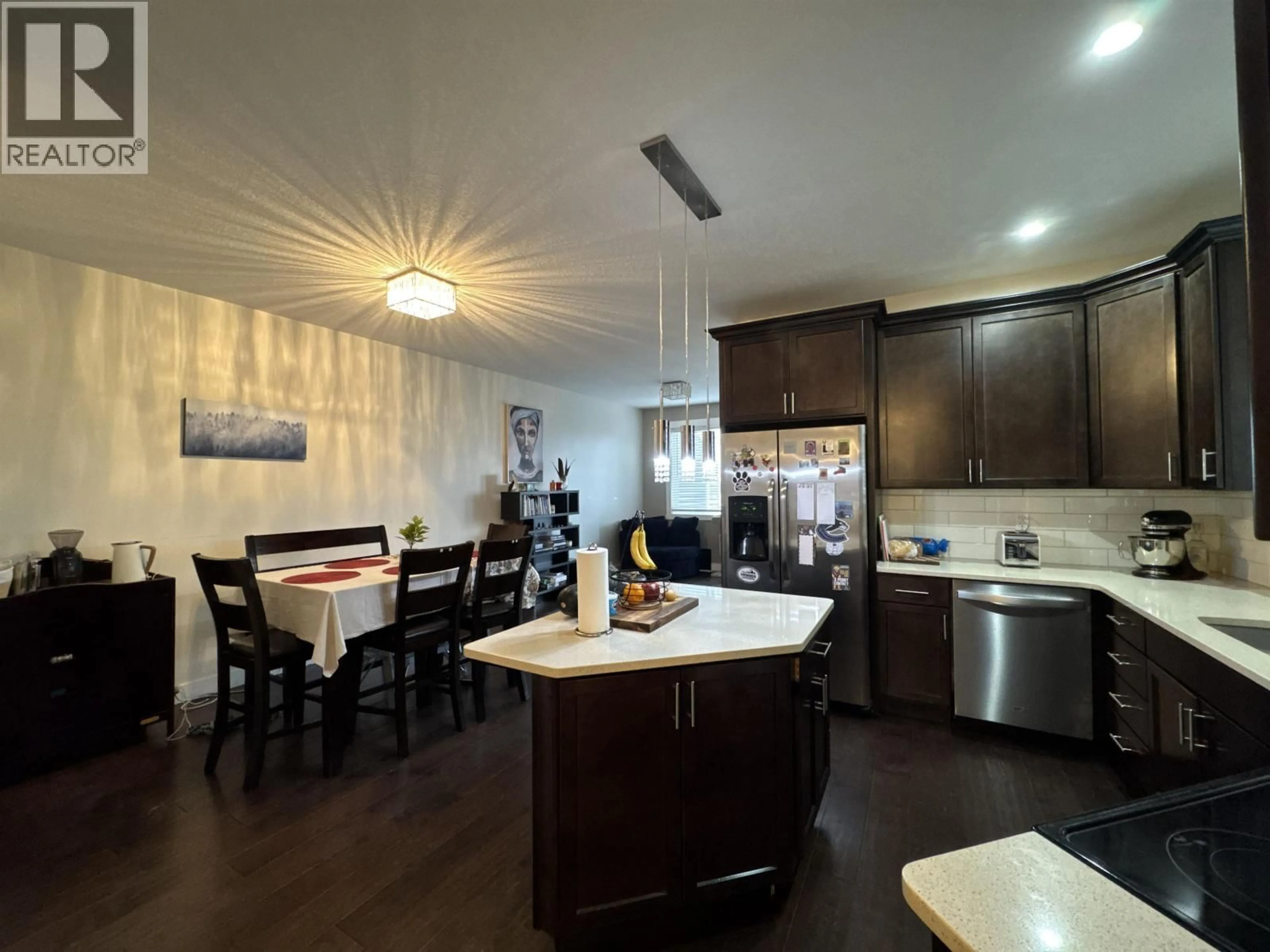 Open concept kitchen, wood/laminate floor for 8618 74 STREET, Fort St. John British Columbia V1J7J6