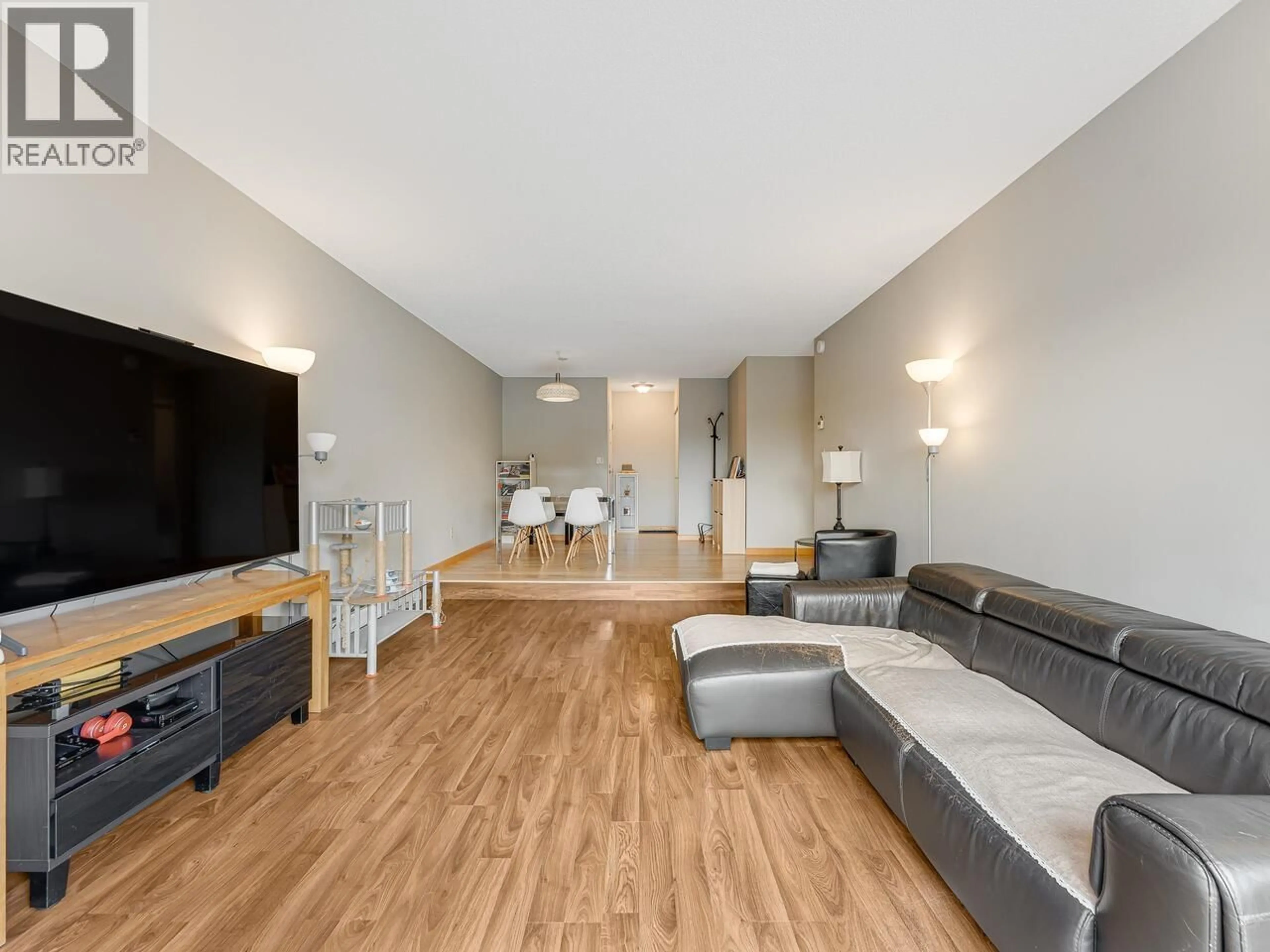 Living room with furniture, wood/laminate floor for 305 - 8760 NO. 1 ROAD, Richmond British Columbia V7C4L5
