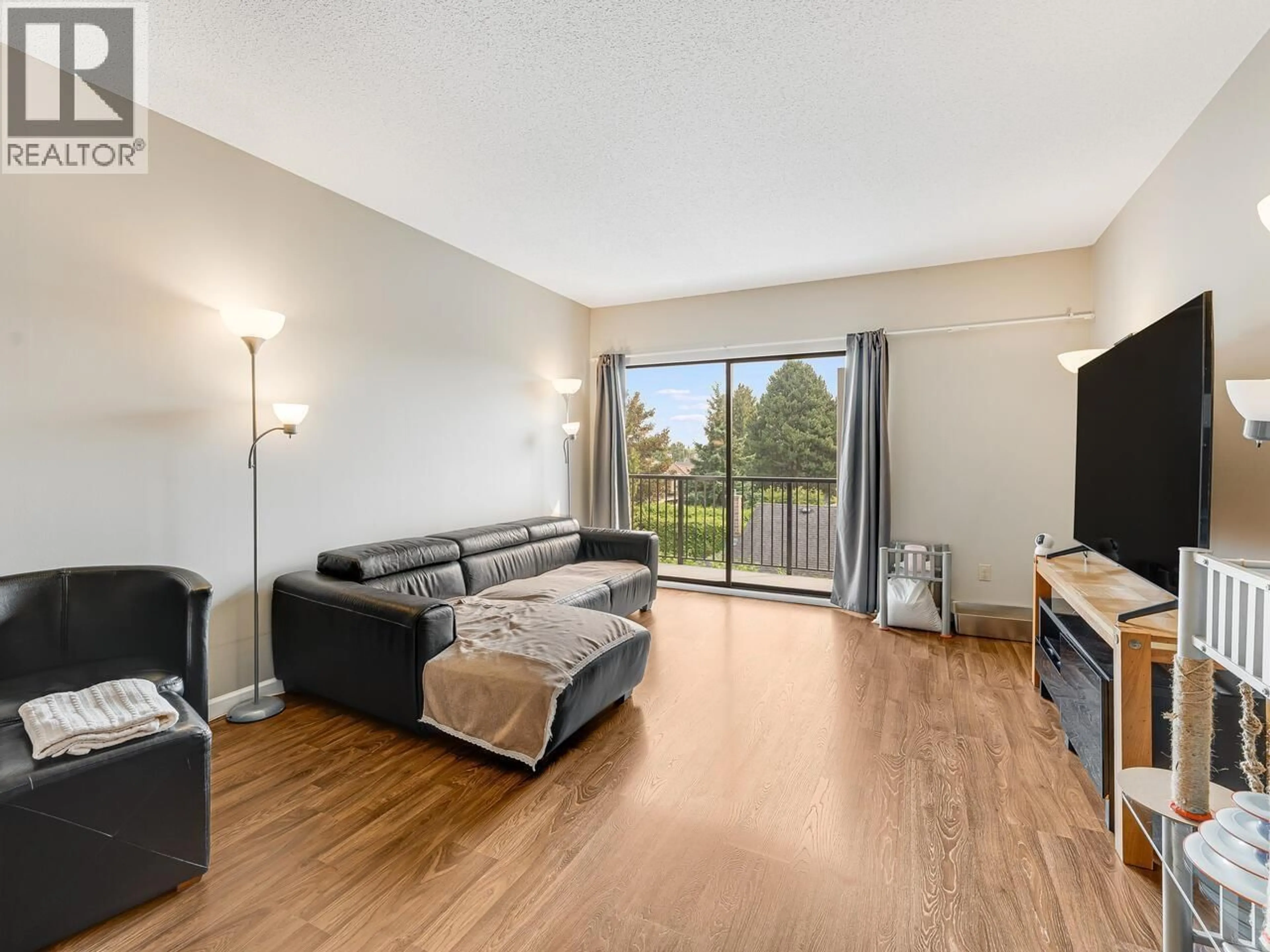 Living room with furniture, wood/laminate floor for 305 - 8760 NO. 1 ROAD, Richmond British Columbia V7C4L5